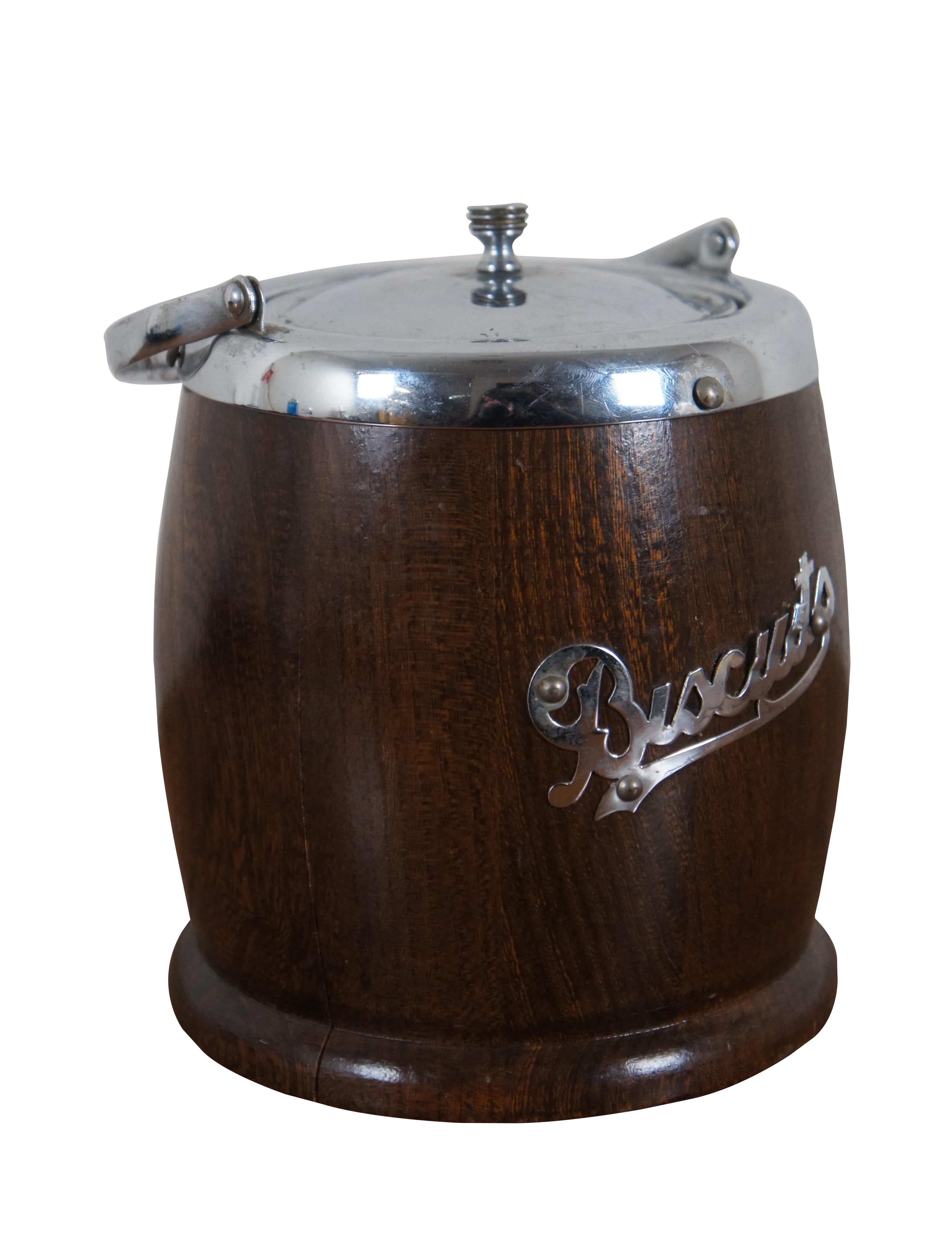 Mid 20th century biscuit / cookie barrel by Lancraft Woodware. Features a traditional barrel shape in dark wood with footed base. Chrome rim, bail handle, lid, and the word 