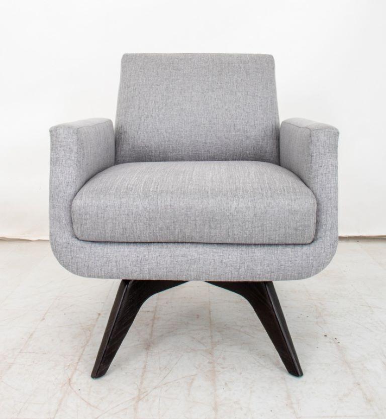 Mid Century Landon Swivel Chair with gray upholstery and four wood  legs. 
