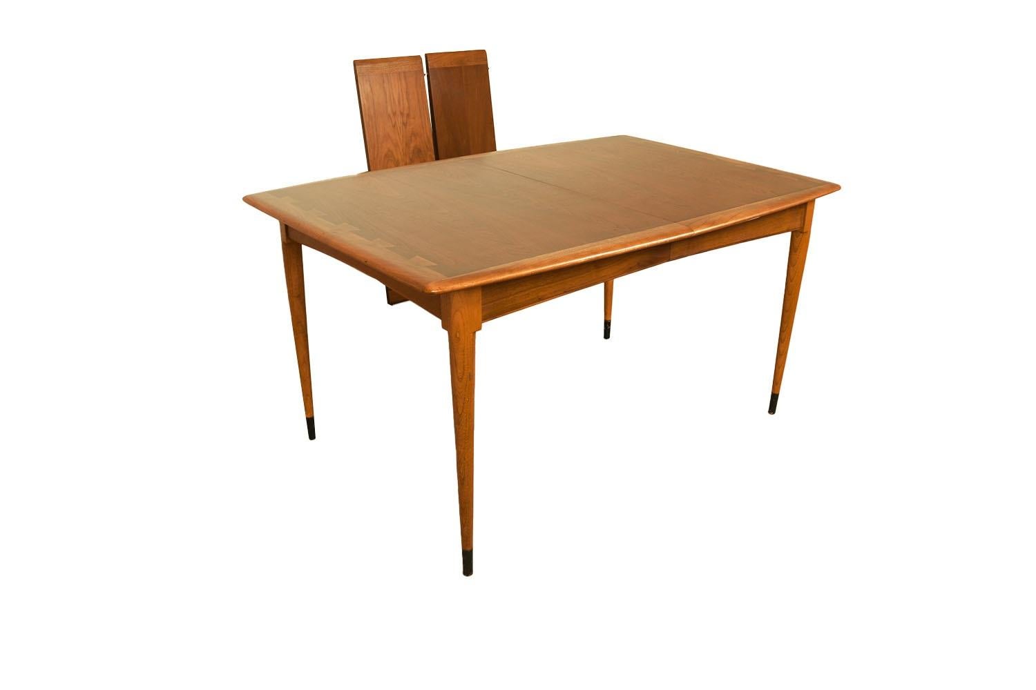 Beautiful Mid-Century Modern expandable, Dovetail Dining Table, in great original condition, manufactured by Lane. Features richly grained, rectangle top accented with dovetailed border. Raised over four tapered legs, creating a clean and elegant