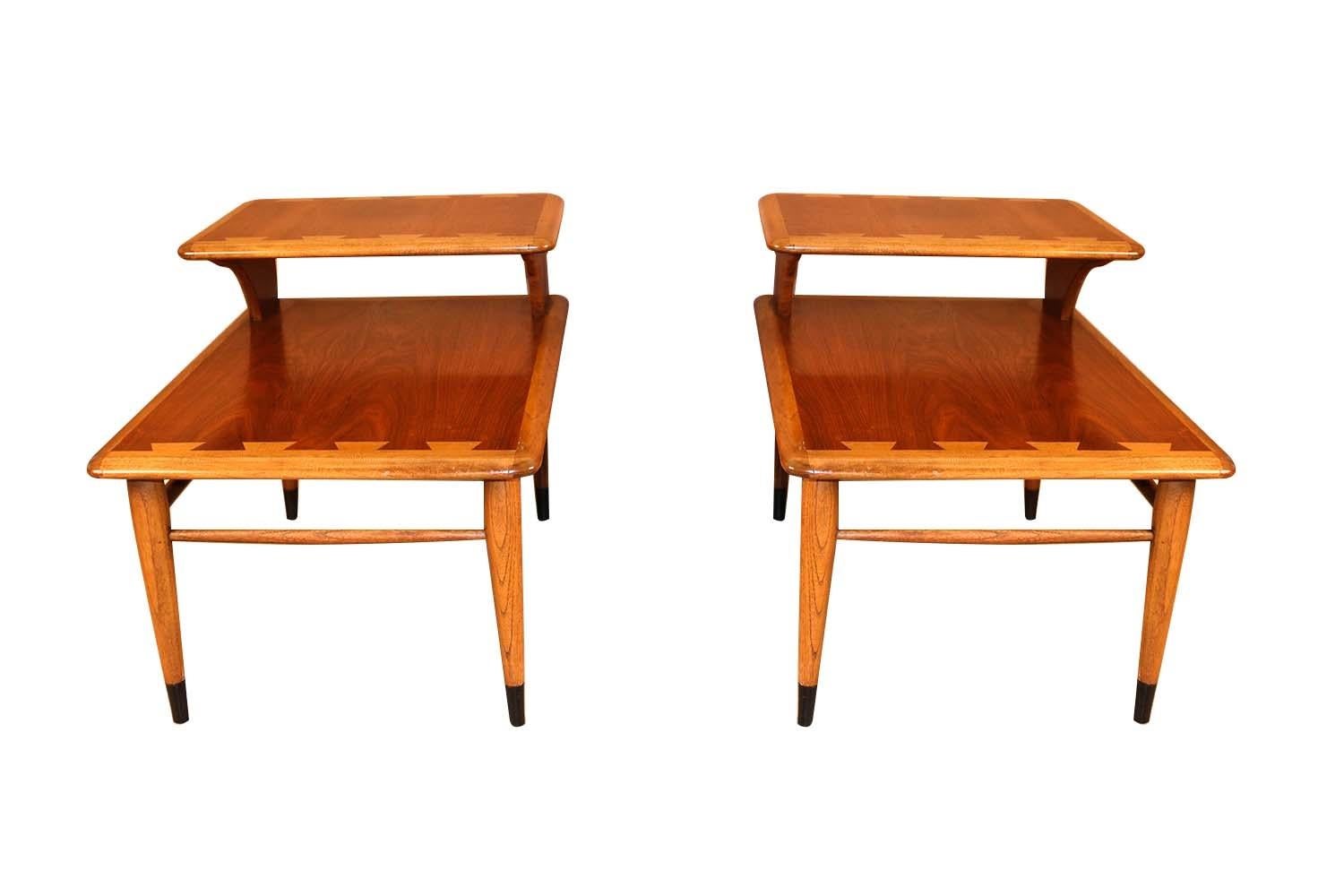 A beautiful pair of two-tier step-up end tables by Lane Furniture Co. from the Lane ‘Acclaim’ collection, designed by Andre Bus. Remains in good condition throughout. Featuring stunning, two tier, signature dovetailed design, in a vivid contrast
