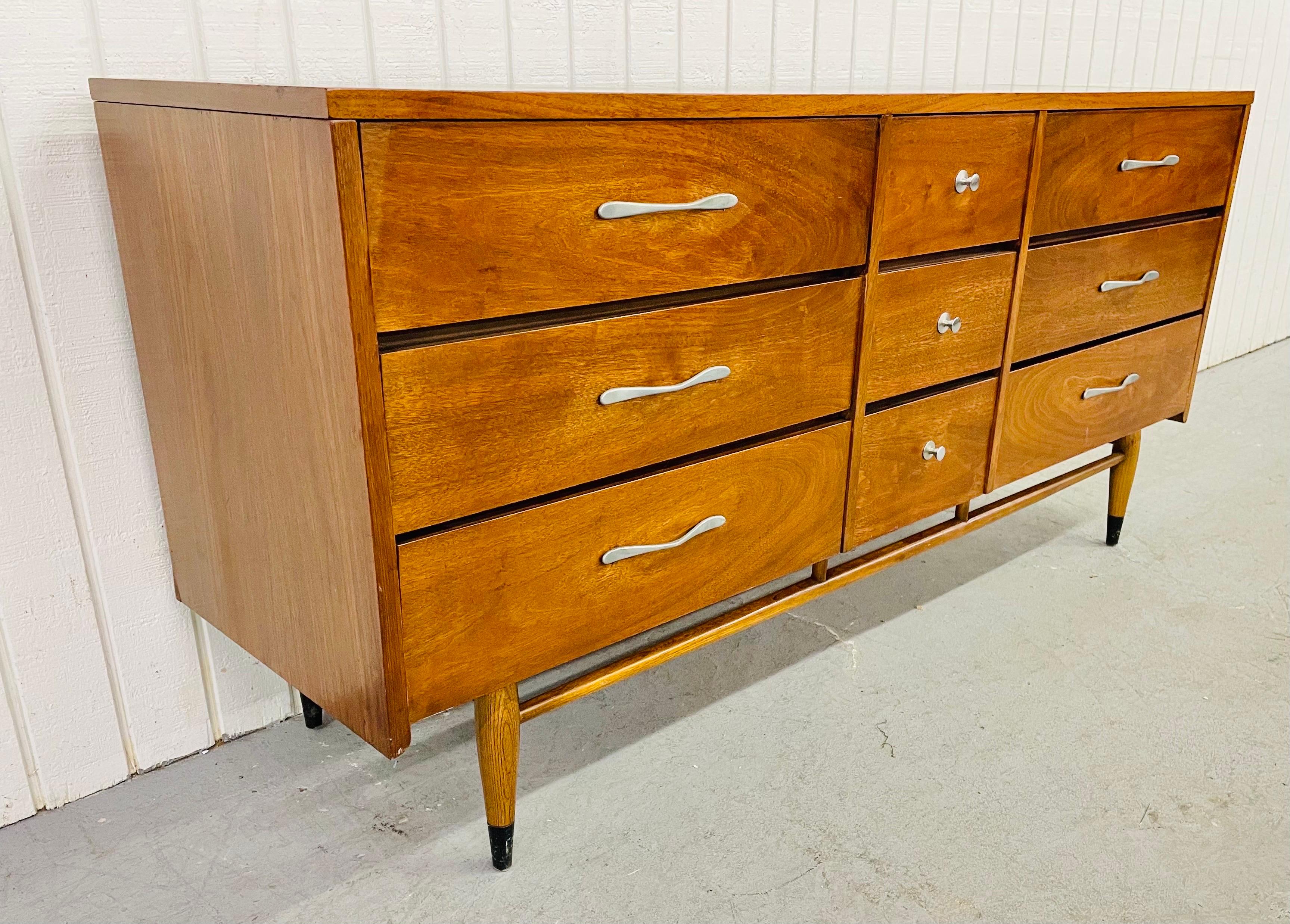 This listing is for a Mid-Century Lane Acclaim Walnut triple dresser. Featuring nine drawers for storage, original chrome pulls, a dovetailed top, stretcher between the legs, black caps on the feet, and a beautiful walnut finish.