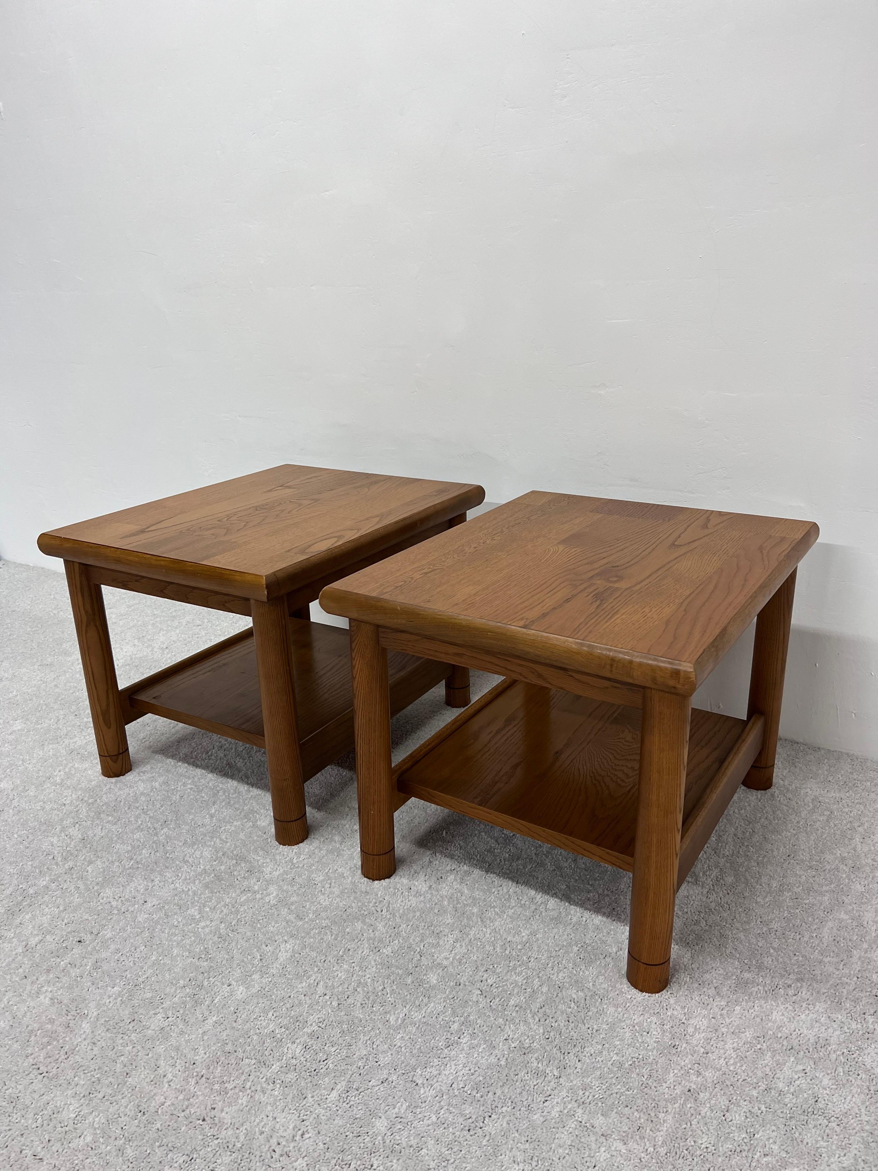 Pair of mid-century Lane Altavista oak side tables with lower shelves.