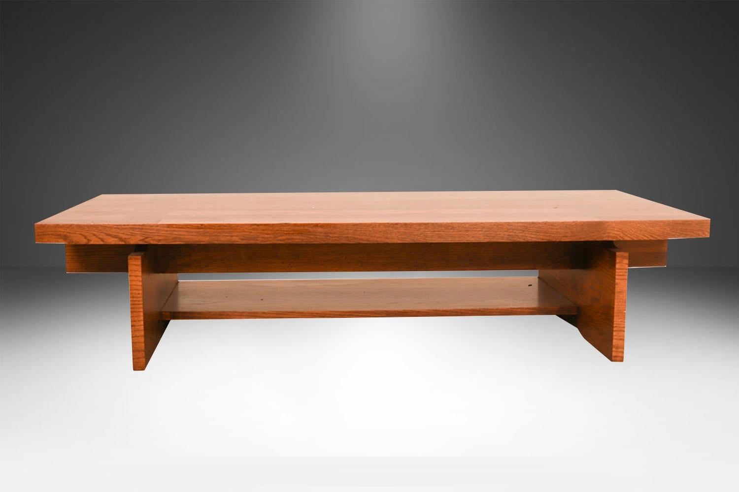 A beautiful coffee table /bench by Lane Furniture Co. in a chunky Brutalist style. Featuring semi parquet oak on top, in a vivid contrast against the surface, with a dramatic, wide square top resting on a trestle style base with lower shelf.