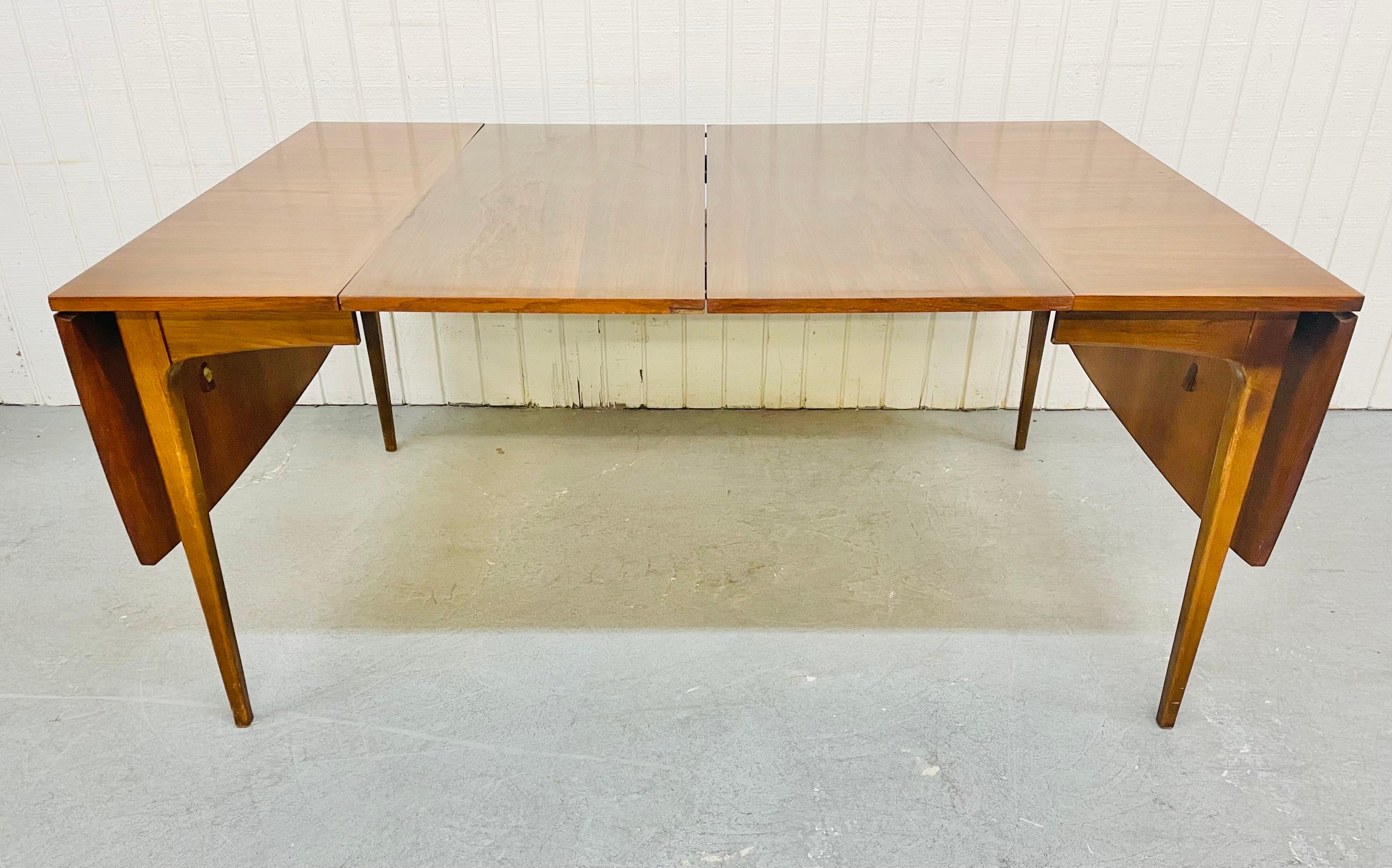 This listing is for a Mid-Century Lane Rhythm Walnut drop-leaf dining table. Featuring two drop leaf sides that extend the table from 28” to 62” L , two original 18”leaves that extend the table up to 98” L, and a beautiful walnut finish.