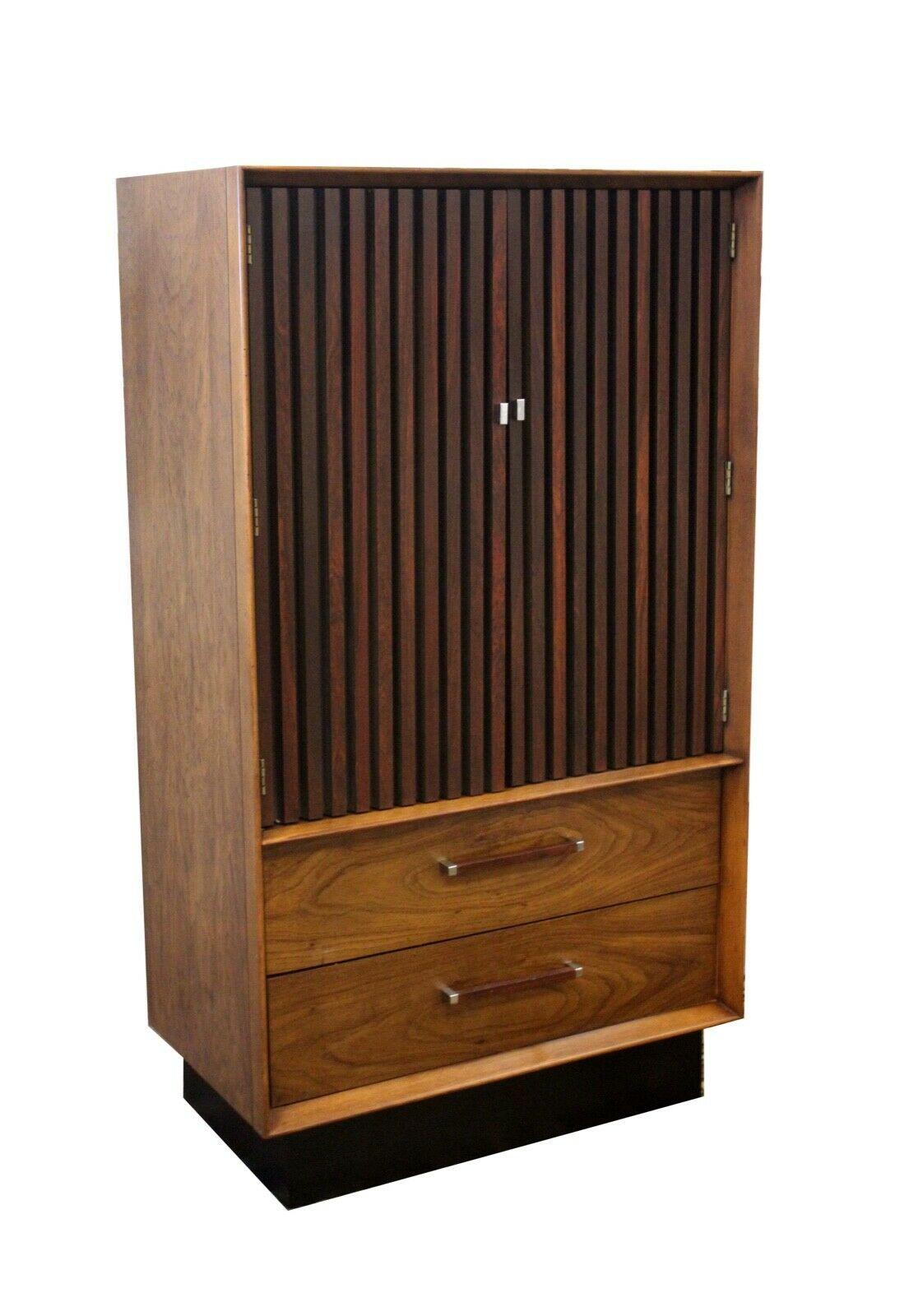 From Le Shoppe Too in Michigan comes this wonderful vintage modern armoire tallboy or gentleman's chest with storage. Known as the Lane 'Tower' Suite, this unique two-tone design with walnut casing and rosewood accents offers both beauty as well as