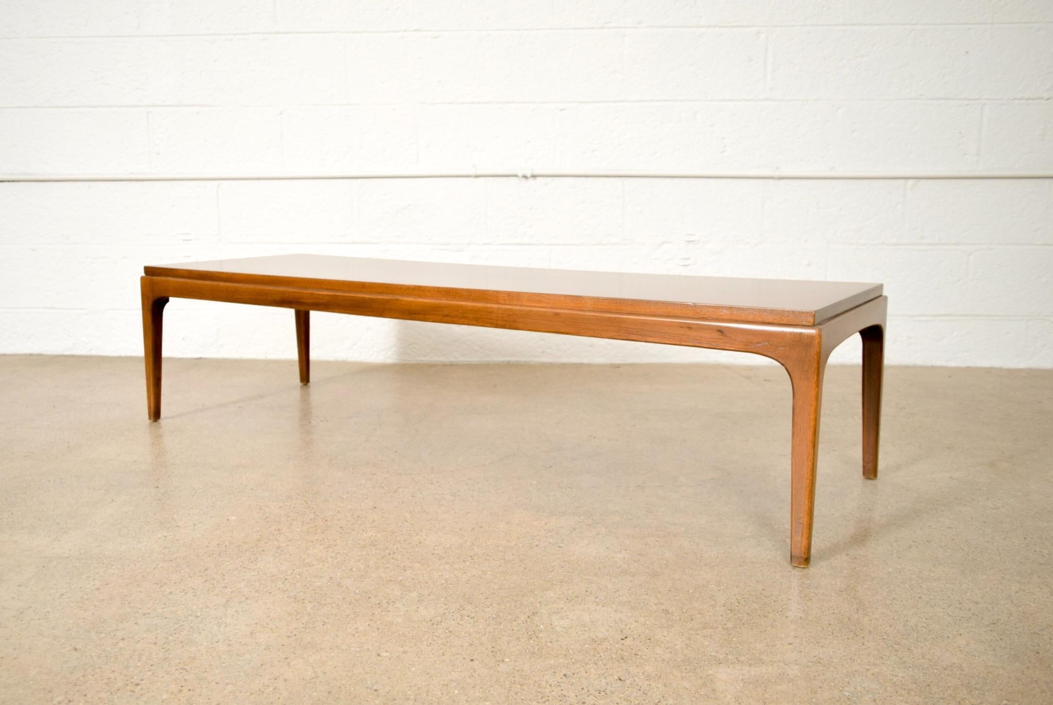 • Vintage Mid-Century Modern Lane rectangular coffee table from 1962.
• Simple, geometric lines and sleek low profile.
• Well constructed from walnut with beautiful inlaid tabletop edge and squared tapered legs.

Marked on underside:
Lane