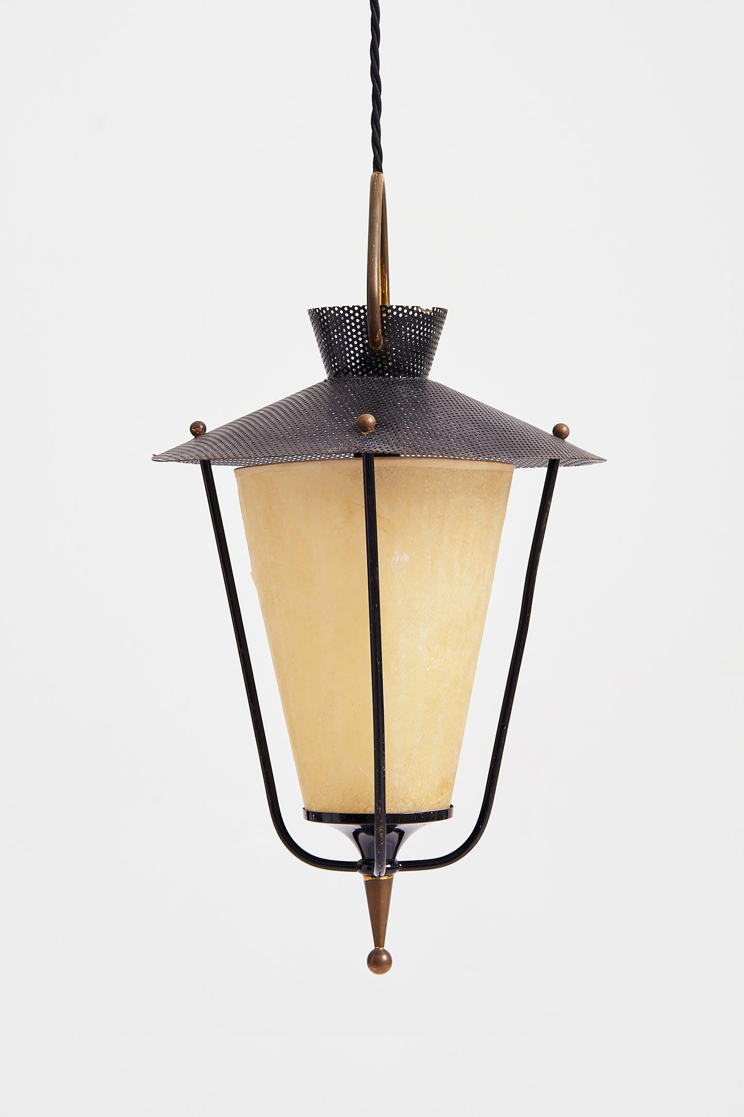 A lantern by Maison Lunel, brass, black enamelled iron and rigitule lantern, with its original parchment paper shade,
France, Circa 1955.
44 cm high plus any length of flex desired.