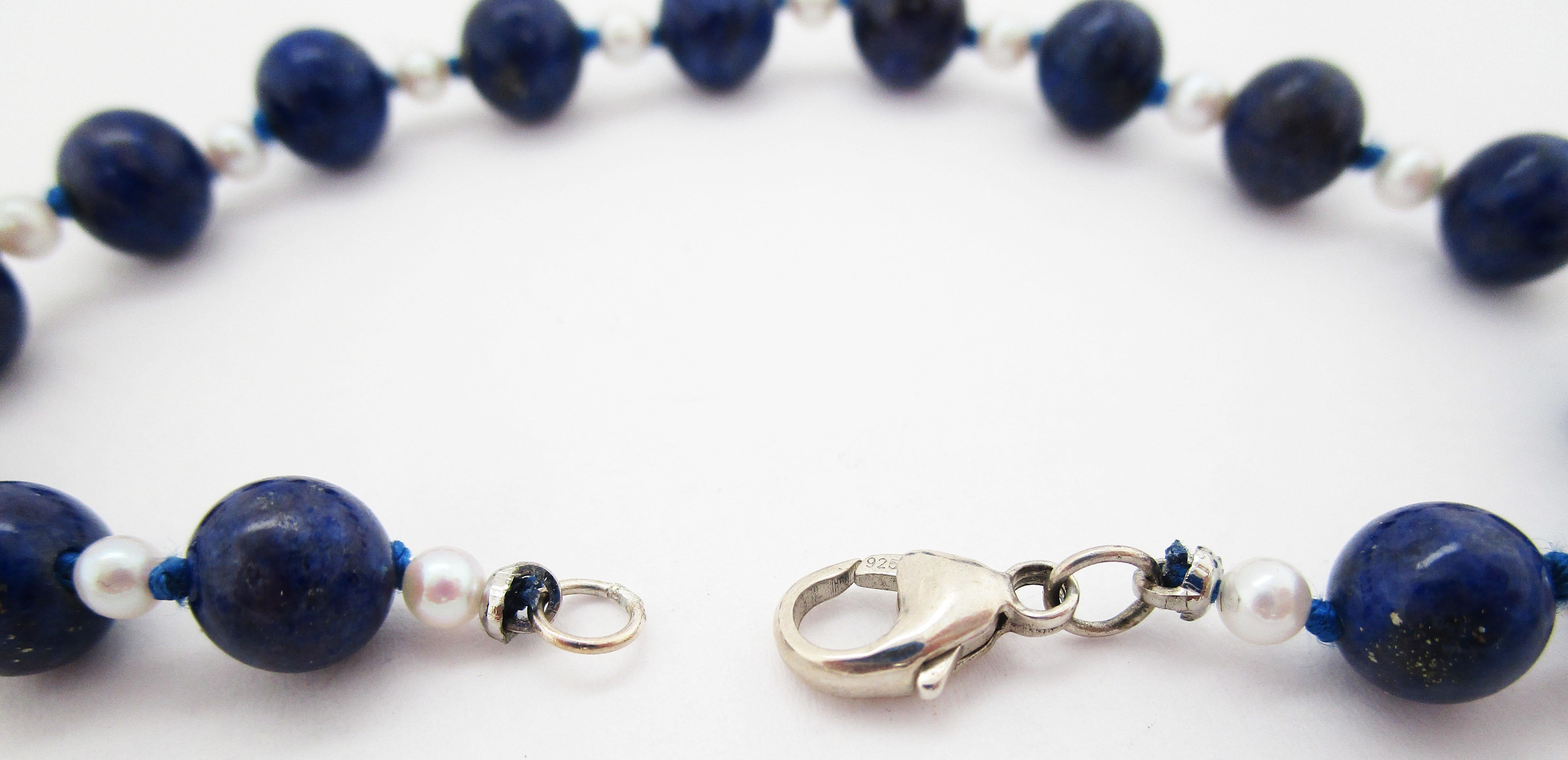 This is a wonderful mid-century lapis and pearl bracelet featuring an alternating pattern of 3mm pearls and 7mm lapis beads. The lapis features rich royal blue tones accented with the subtle flecks of gold characteristic of only the finest lapis!