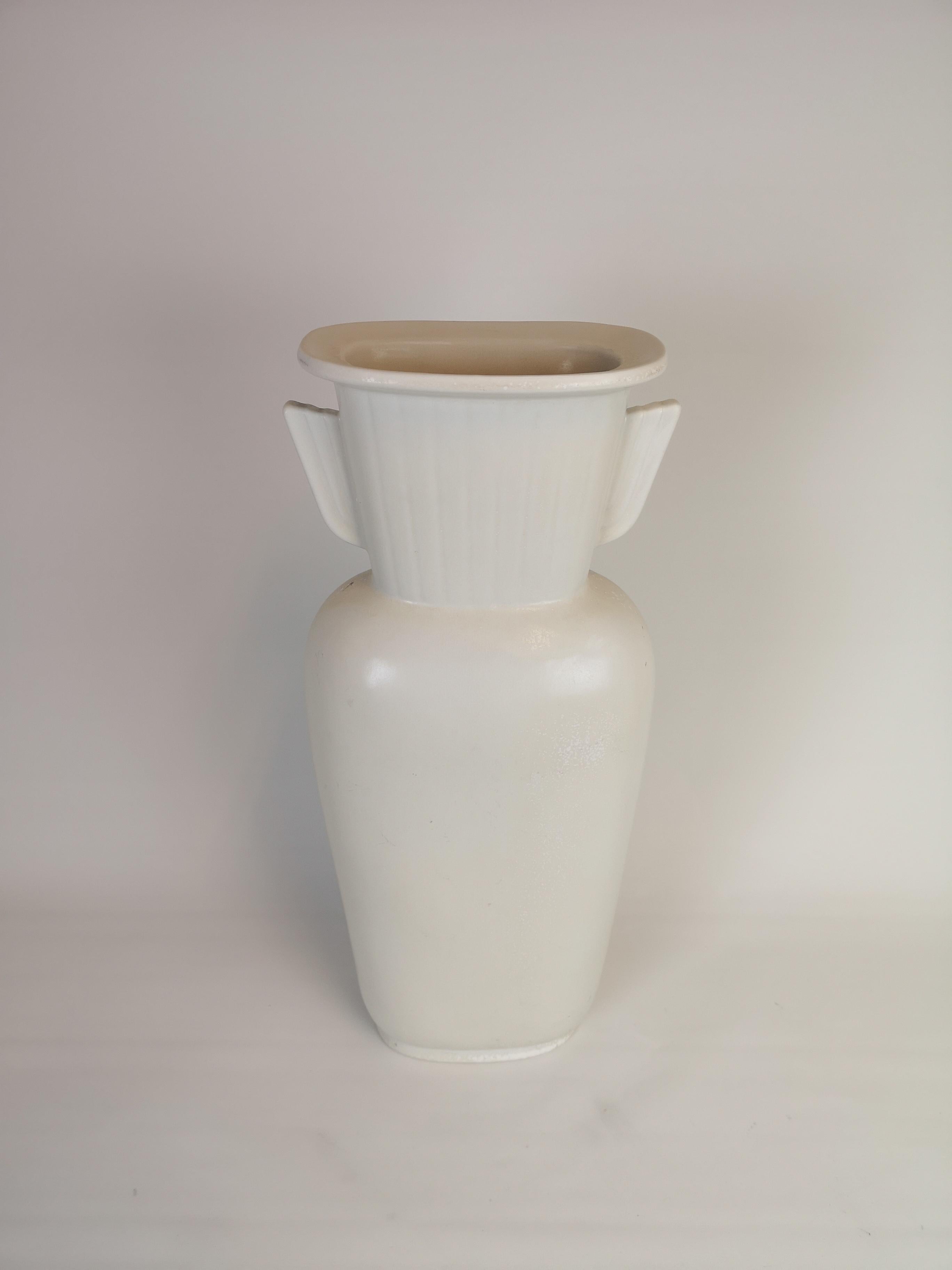 This stunning vase was made in Sweden at Rörstrand and designed by Gunnar Nylund. 

The structure of the vase is a reminder of how the ancient Greek urn and vases vas done. However, this one, also got a very nice glaze.

Good condition with some