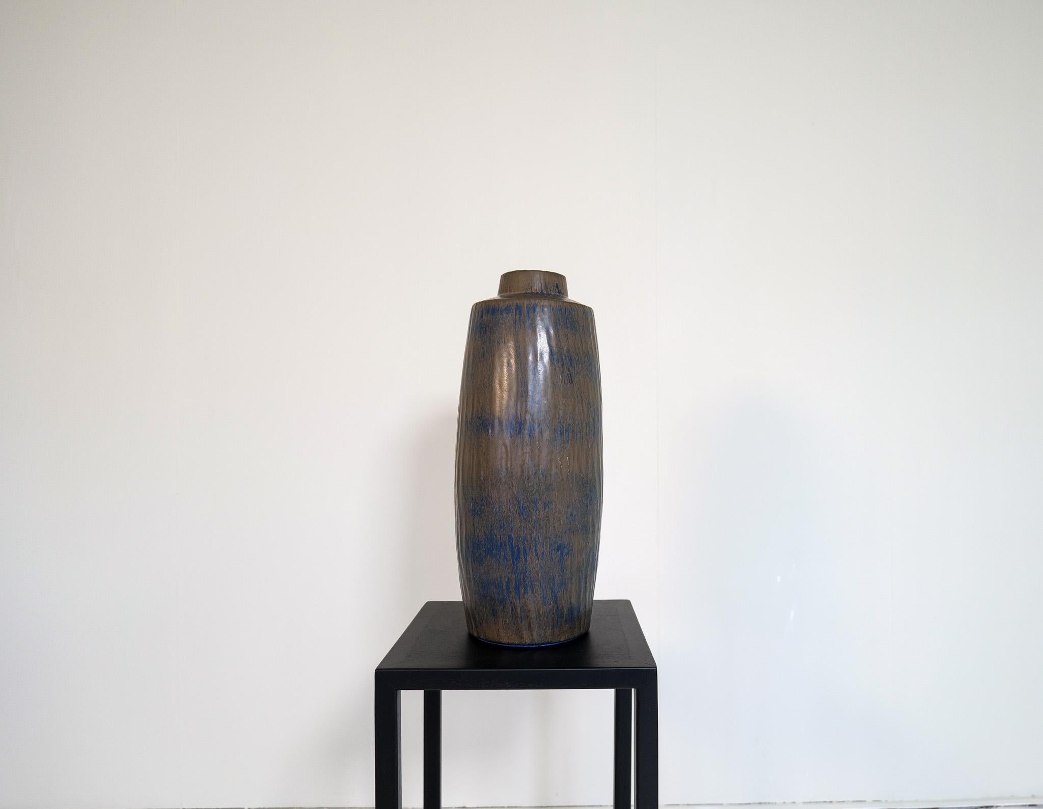 Wonderful large vase in ceramic named Rubus and designed by one of the ceramic designer icons of Sweden Gunnar Nylund. This one with incredible colors in blue, grey and dark brown. 

Good vintage condition, with wear. 

Dimensions: Ceramics H 52 cm