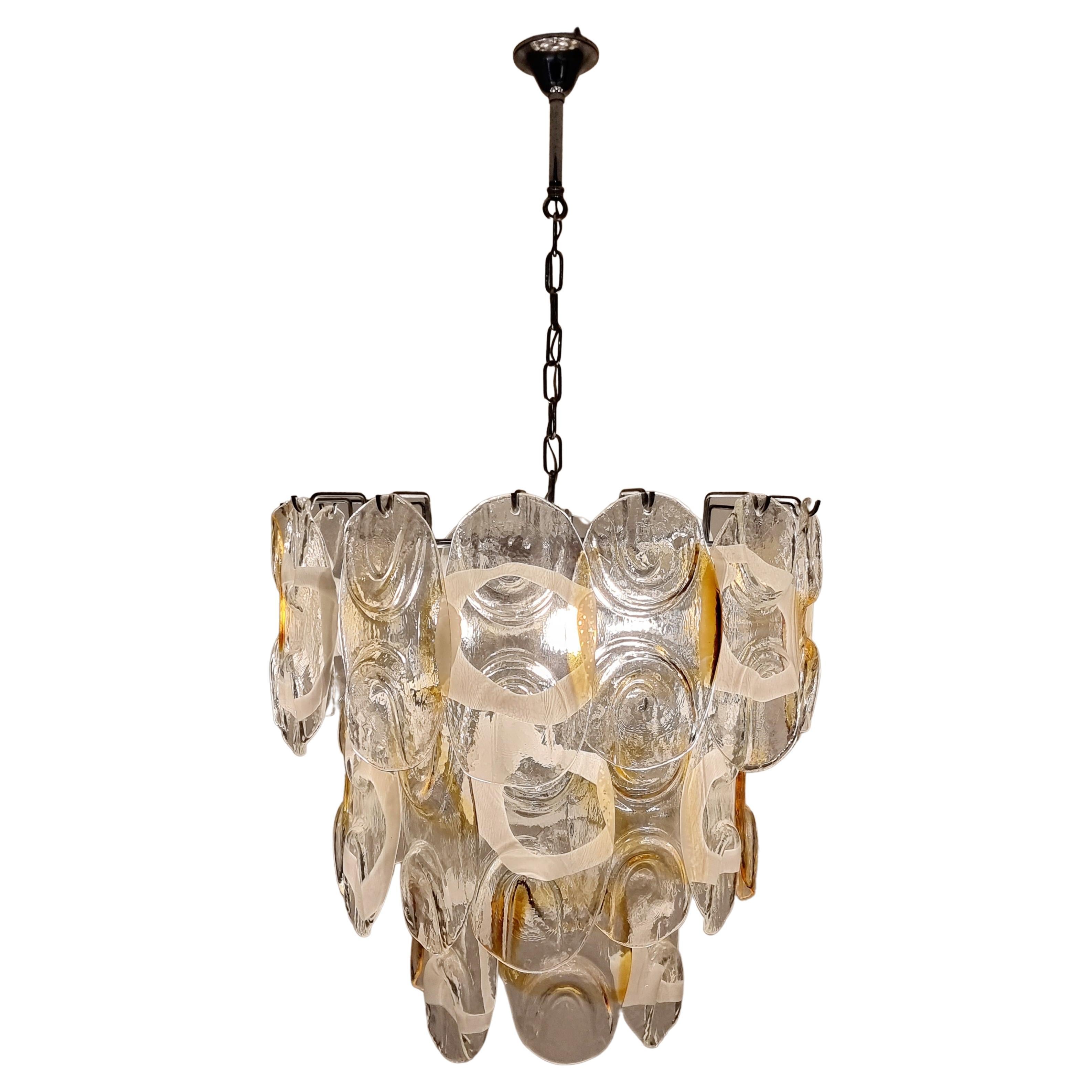 Stunning vintage Murano glass chandelier made in Italy in the 1970s. Consists of 32 glass plates of Murano glass, made by Italian glassblowers. They follow the oldest Murano glassmaking technologies that were invented on the island of Murano. Each