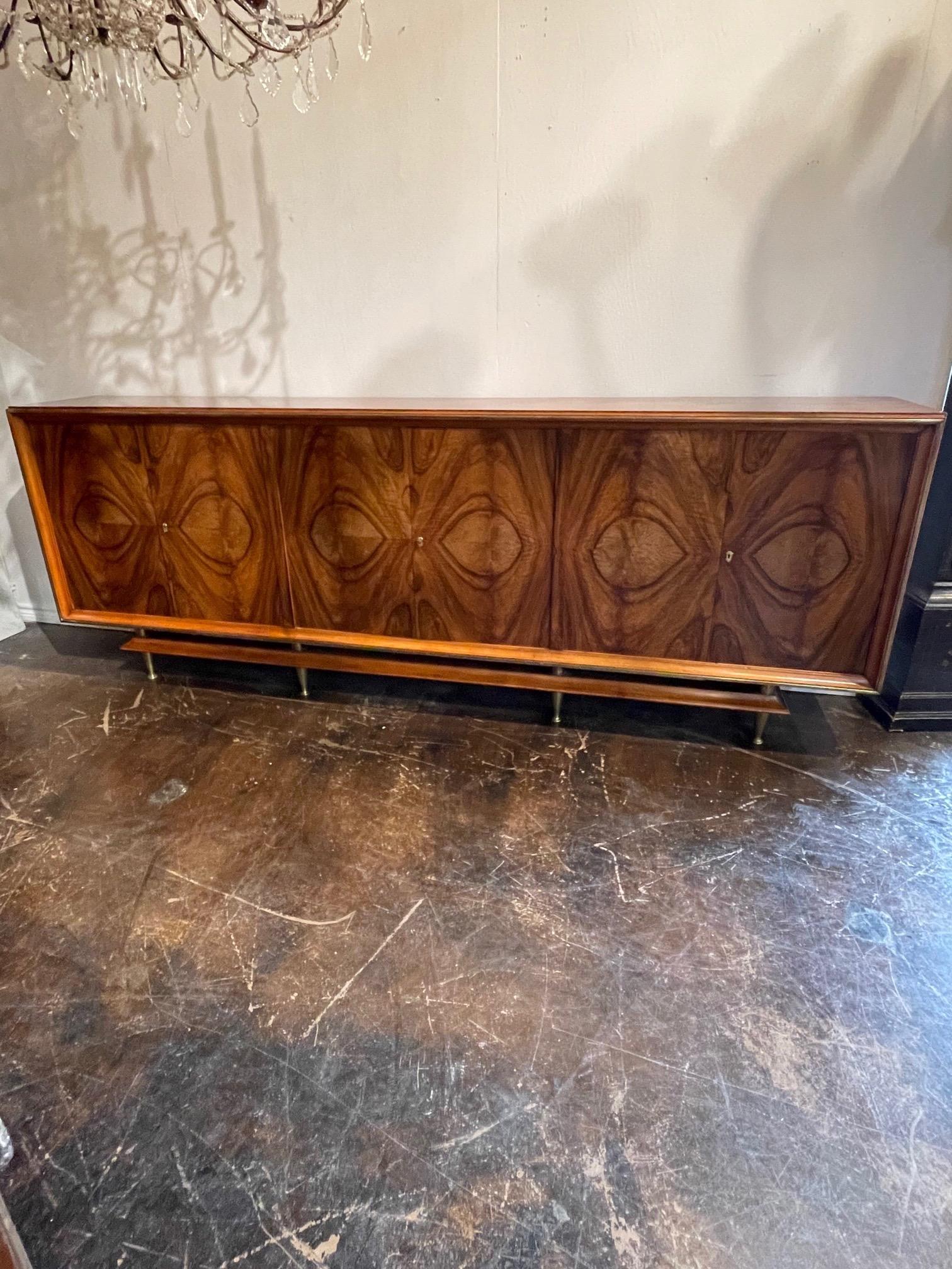 Exceptional mid-century large scale Italian black walnut and brass sideboard. This beautiful piece has an amazing matched veneer pattern. An exquisite server with tons of storage that creates a very high end look. Stunning!!