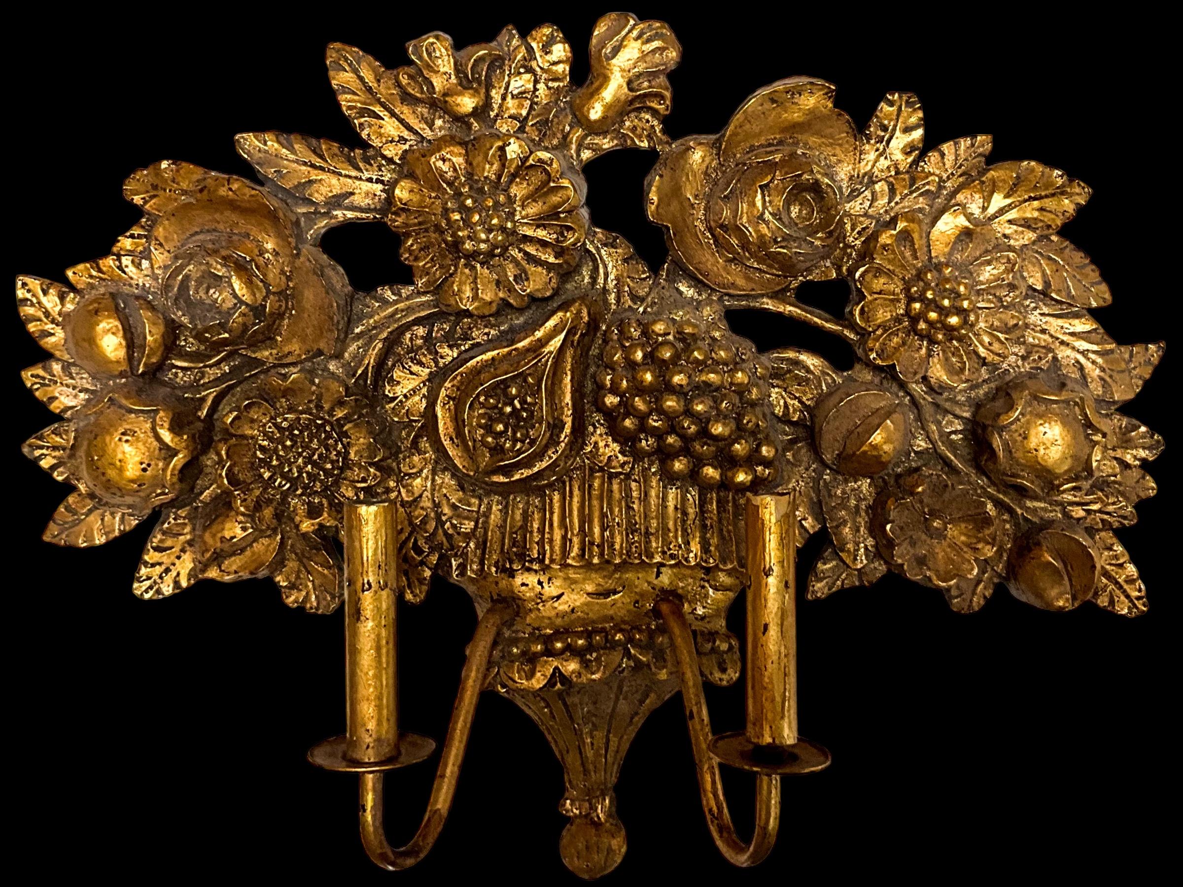This is a mid-century large scale regency style Italian fruit and floral gold leafed sconce. It is gesso over cast plaster. It is unmarked and in working order.