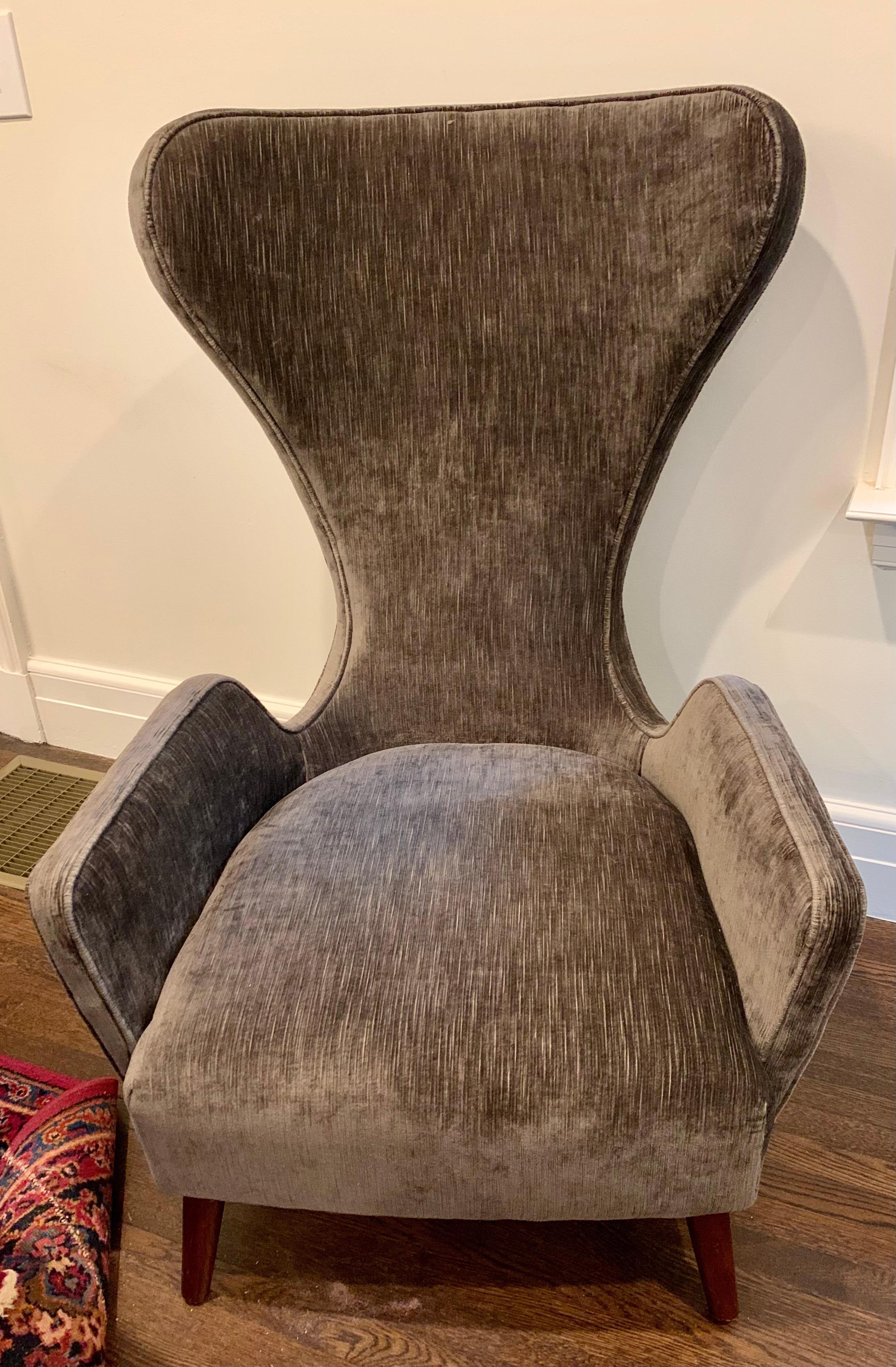 Stunning sculptural mid century wingback chair with coveted curved back and lines to die for. The second of two we will be selling this week exclusively on 1stDibs. Note fabric is almost brand new, less than 3 months old. See pics for color. Now,