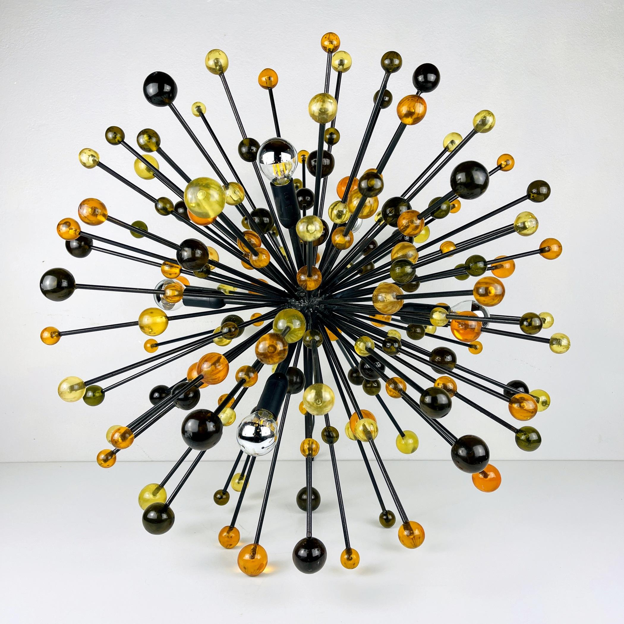 Rare and very unusual table or floor lamp Sputnik.
Made in Italy in the 1970s.
Rays are attached to the central ball, on which there are yellow, orange, green plastic balls. The lamp stands on the rays.
Can be used as a table or floor lamp. It