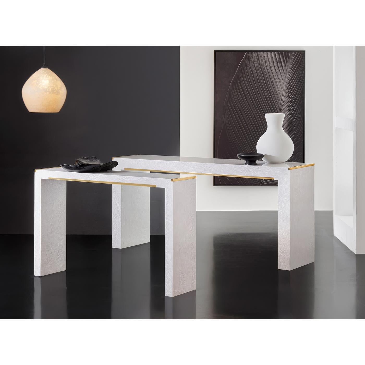 White Console with brass accents combines clean modernist lines with luxurious details, featuring textured lacewood veneer in a crisp white finish. The minimalist design is enhanced by sleek brass trim along the top edge and a subtle brass crossbar