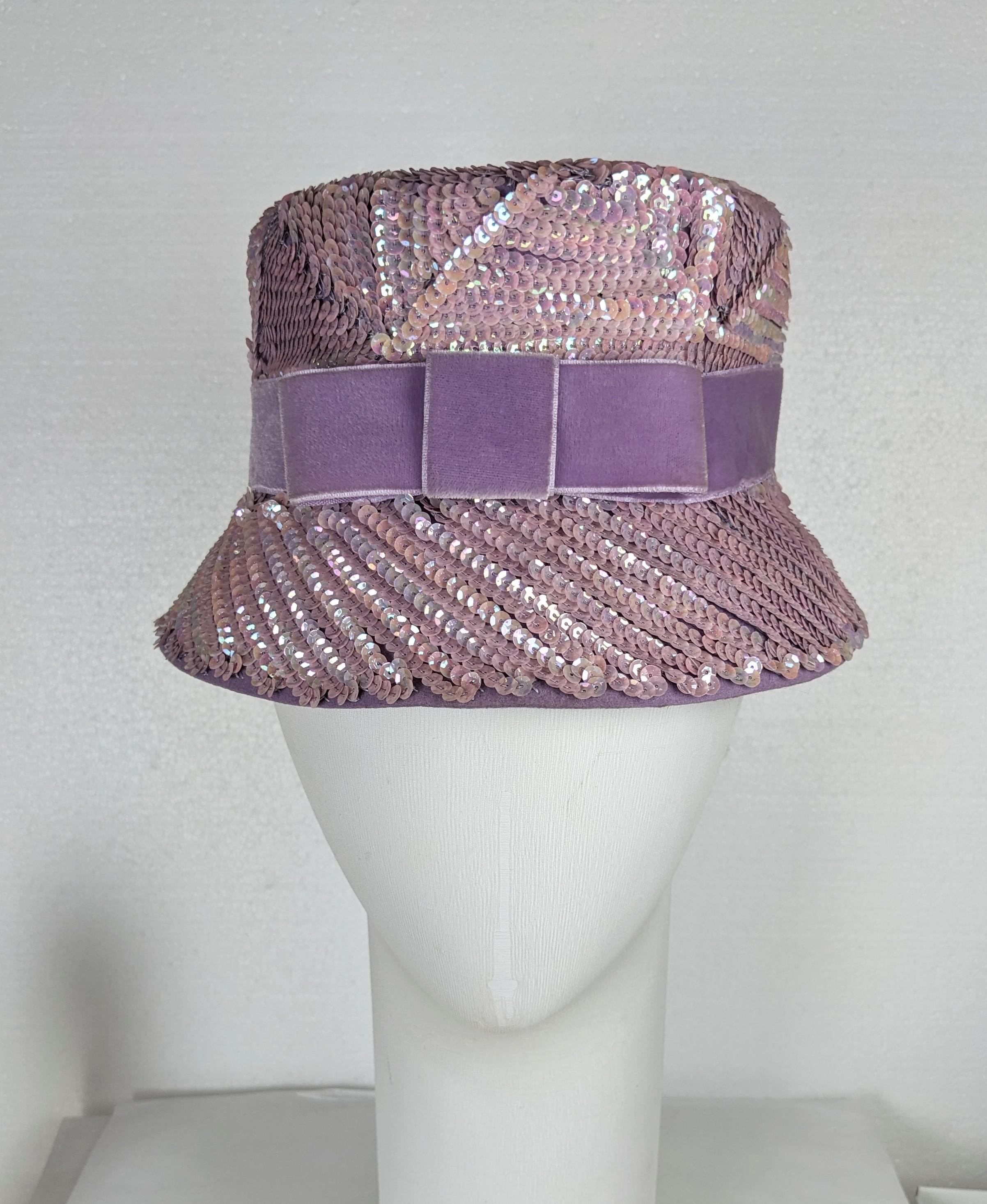 Charming Mid Century Lavender Sequin Bucket Hat from the 1960's. Prada like vibes on wool felt base with sequins sewn in different directions to form spiral pattern, with velvet ribbon bow. Small size. 1960's USA. 