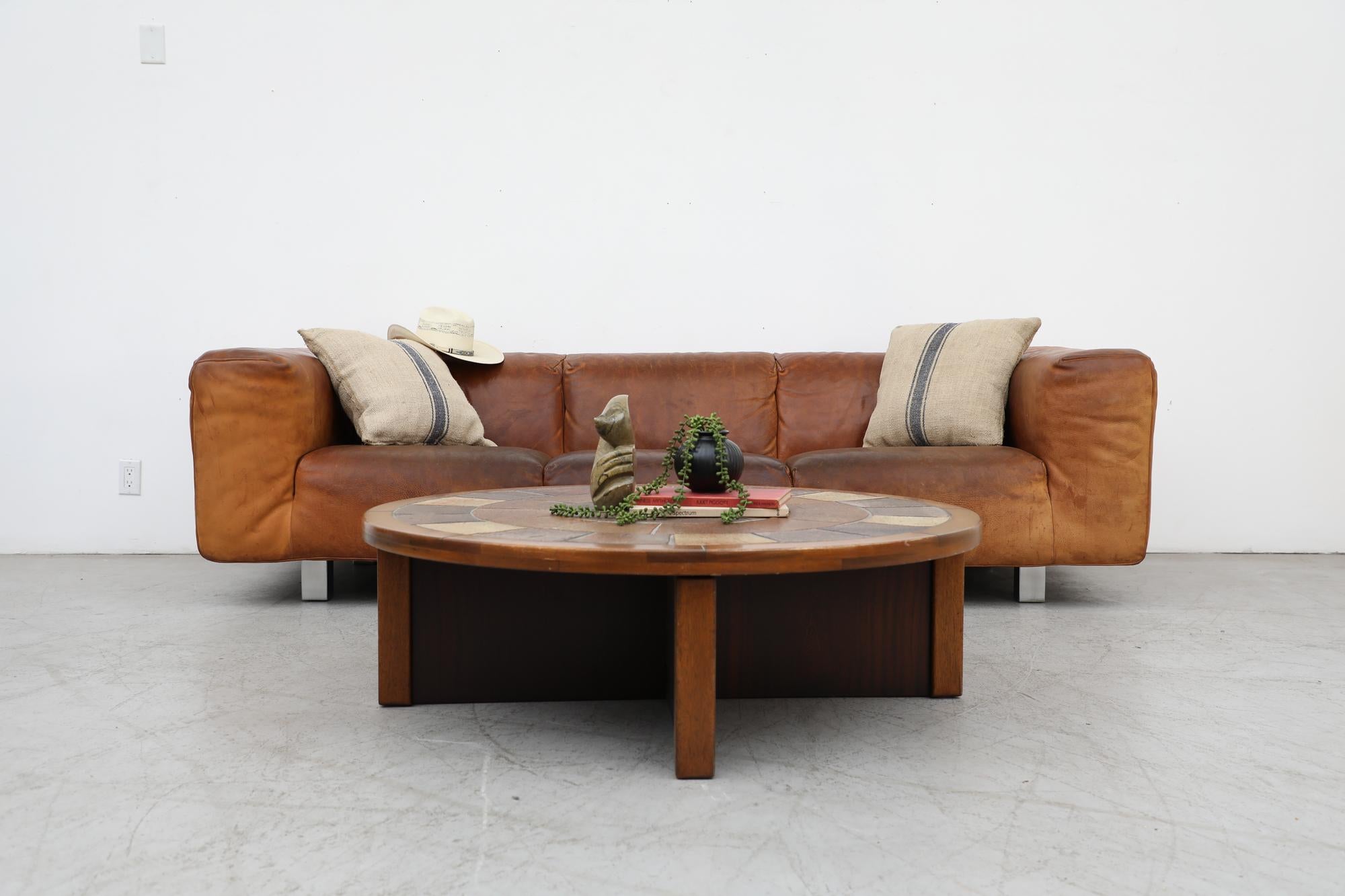 Handsome 1980s Gerard van den Berg Leather Sofa for Montis. Thick cognac toned leather with visible patina and some visible wear consistent with age and casual use. Sofa underlining has small tear patched by previous owner but otherwise original