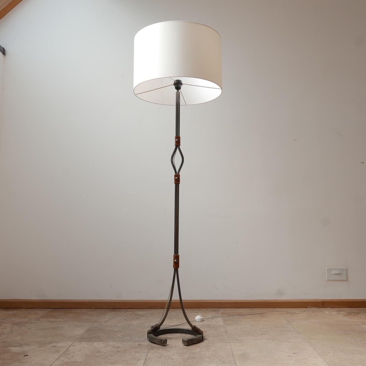 A stylish floor lamp by Jean-Pierre Ryckaert.

France, c1950s. 

Leather and iron. 

Often attributed to Jacques Adnet because of the quality and style. 

Good condition, one small metal plug is missing to the base (see photos). 

Re-wired
