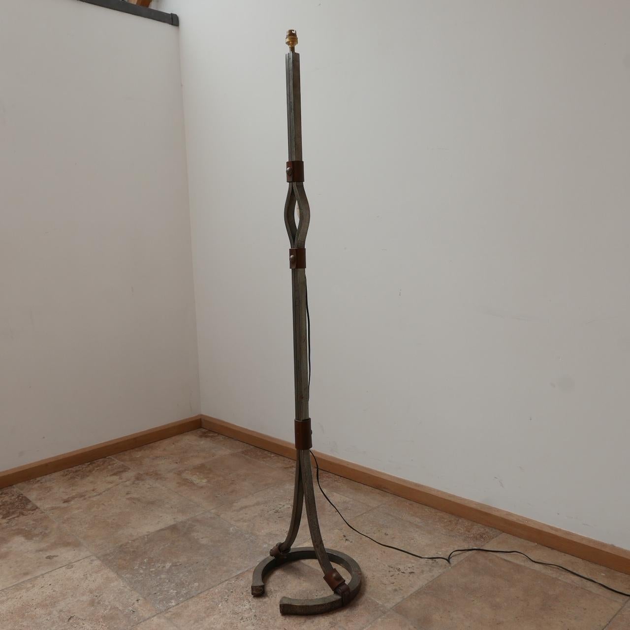 A stylish floor lamp by Jean-Pierre Ryckaert.

France, circa 1950s. 

Leather and iron. 

Often attributed to Jacques Adnet because of the quality and style. 

Good condition, one small metal plug is missing to the base (see photos).