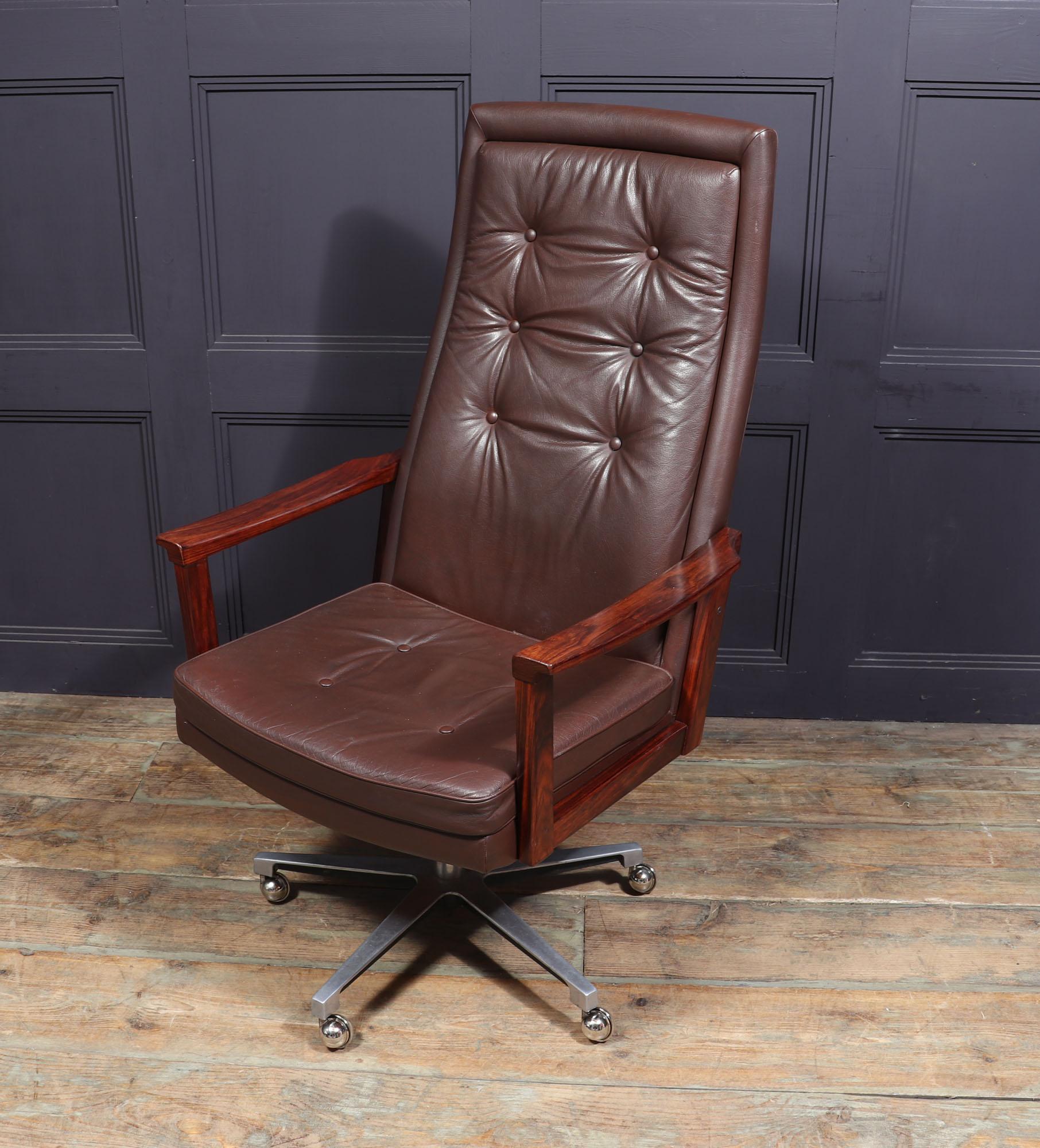 A Danish rosewood and buttoned leather upholstery executive desk chair, with tilt swivel and adjustable height seat this is the king of comfort at any desk. The thick leather upholstery is in excellent condition with no repairs and minimal wear, the