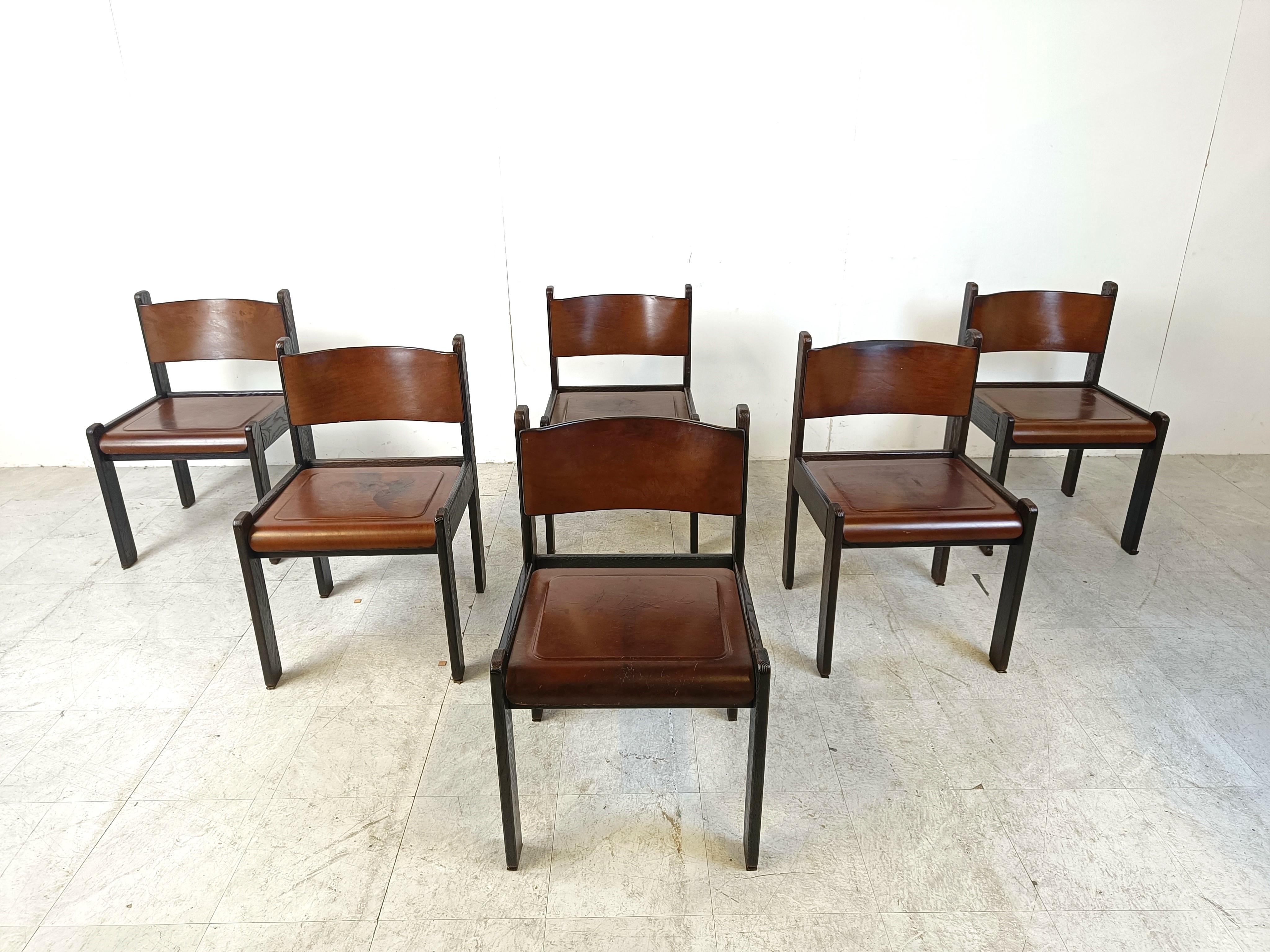 Vintage dining chairs with a black wooden frame and with a thin leather of nicely patinated leather on the seats and backrests.

Unique chairs with a beautiful vintage look.

Good condition with some nice patina, sturdy frames.

1960s -