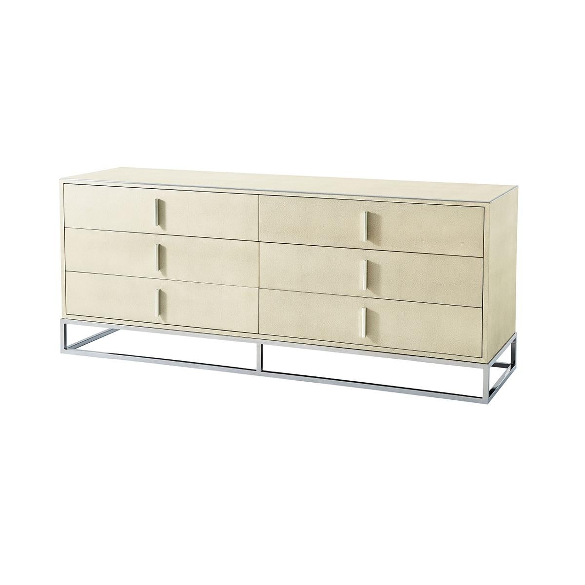 A wonderful collection of modern leather-wrapped bedroom furniture. It consists of a long six-drawer dresser and two low two-drawer nightstands. With polished nickel finish hardware and trim, all raised on a cube form polished nickel base.

Dresser