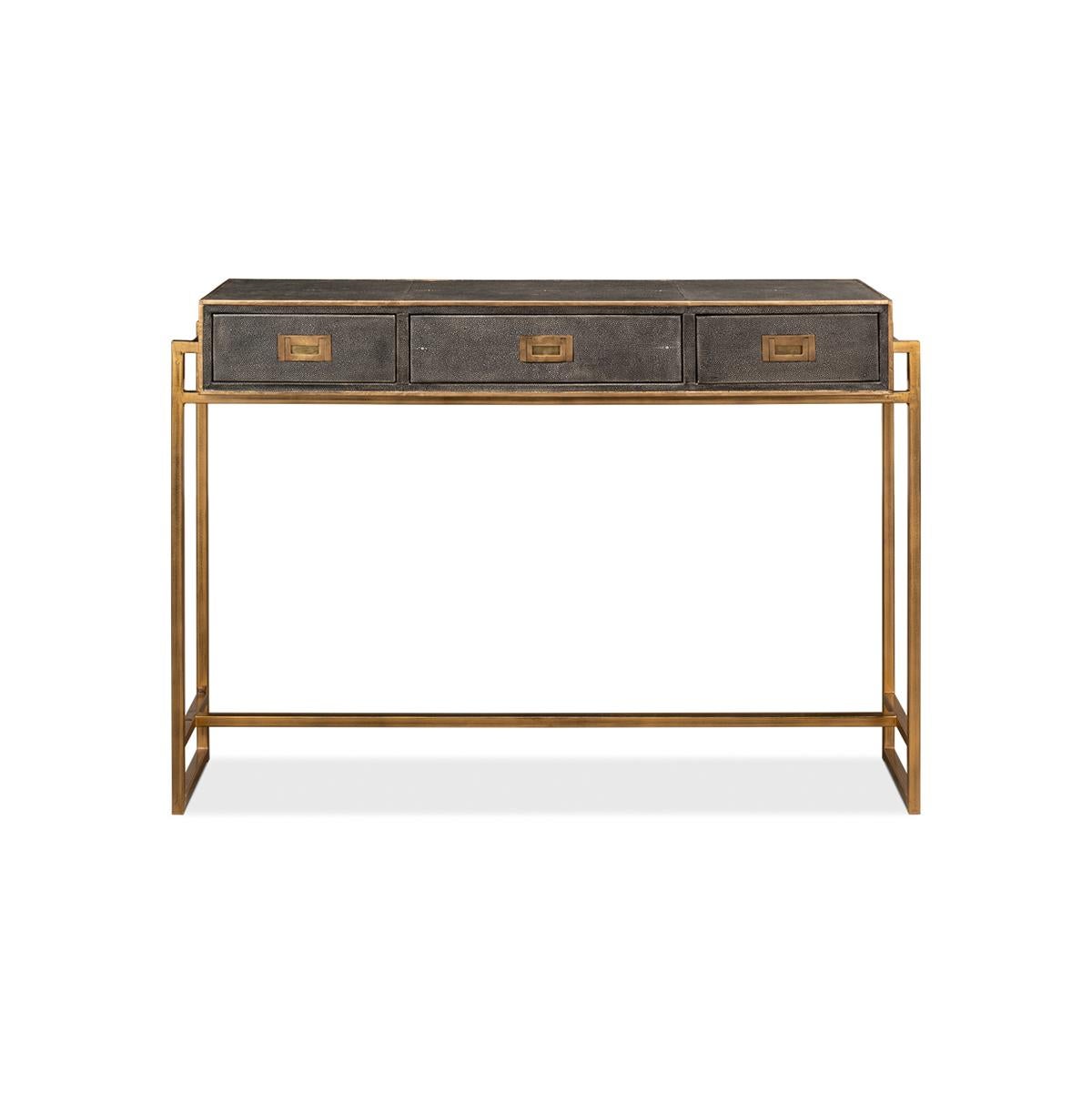 With embossed leather in an antique gray finish highlighted with gold trim. Three drawers lined with marbleized paper on a gilded iron cube form base.

Dimensions: 49