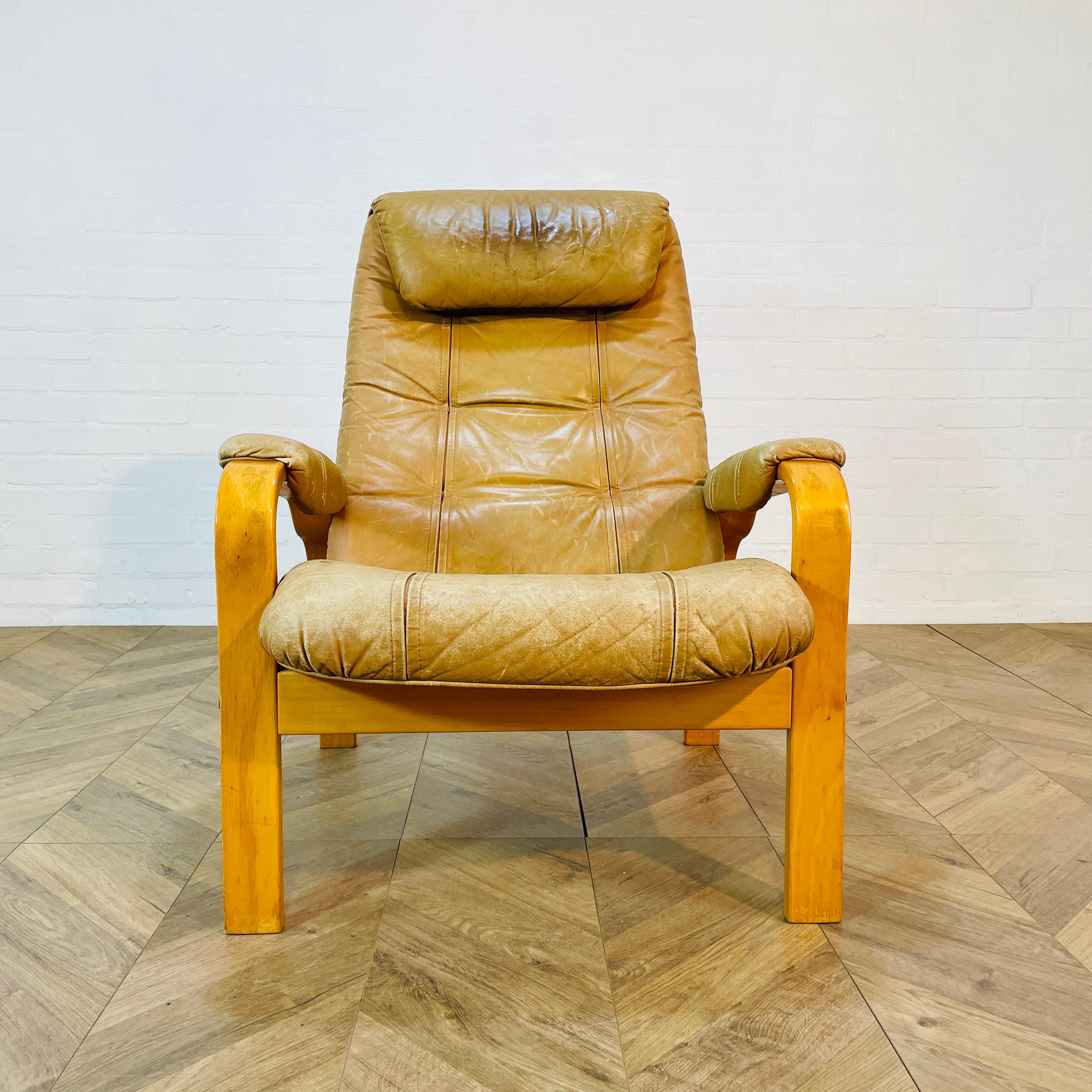A Retro Leather Lounge Chair by Norwegian firm; Skoghaug Industries, circa late 1970s.

The chair is made from a tan leather material and in good vintage condition, with visible wear and slight marks and scuffs to the arms and seat, in-keeping with