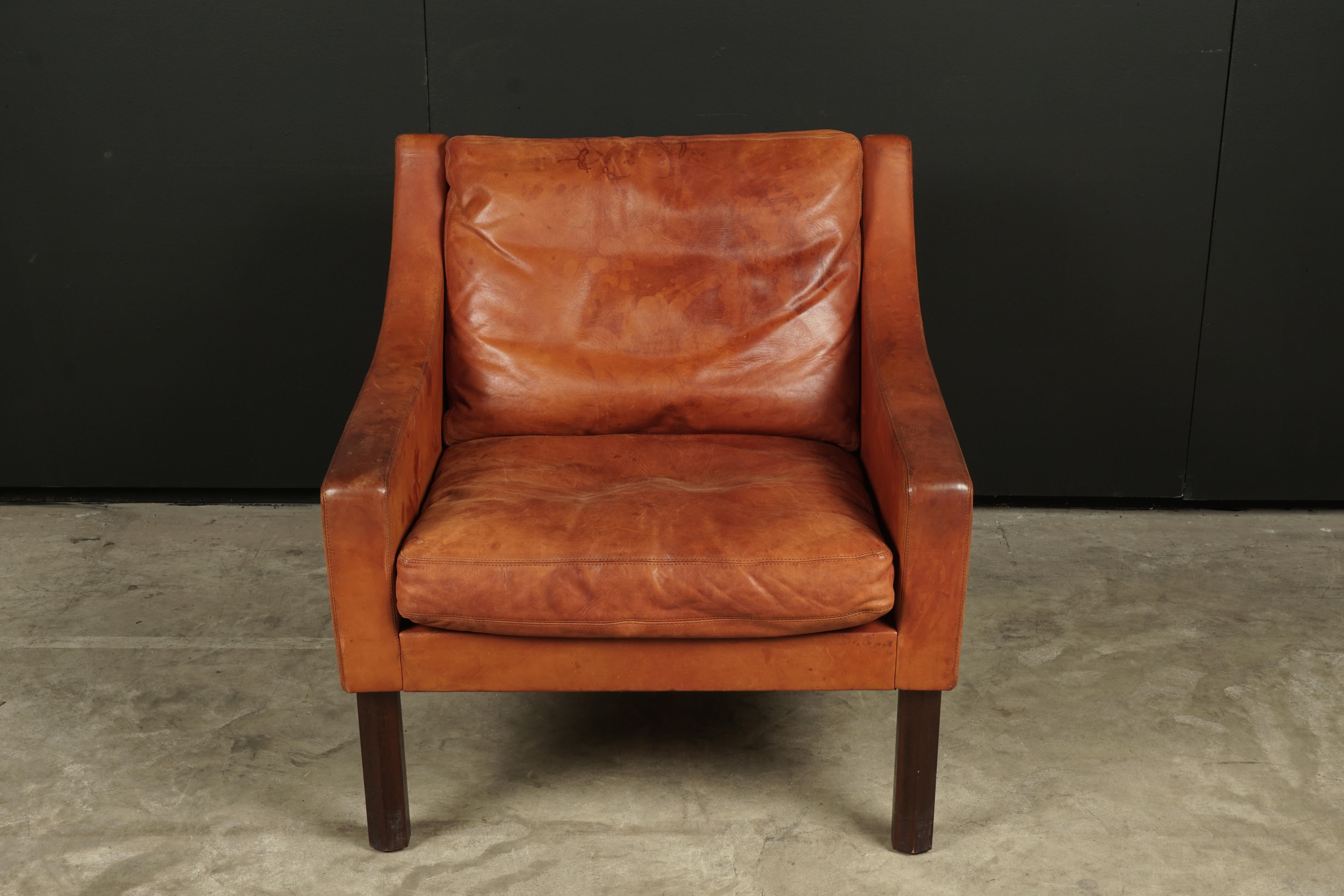 Vintage midcentury leather lounge chair from Denmark, circa 1970. Original cognac leather with great patina and wear.