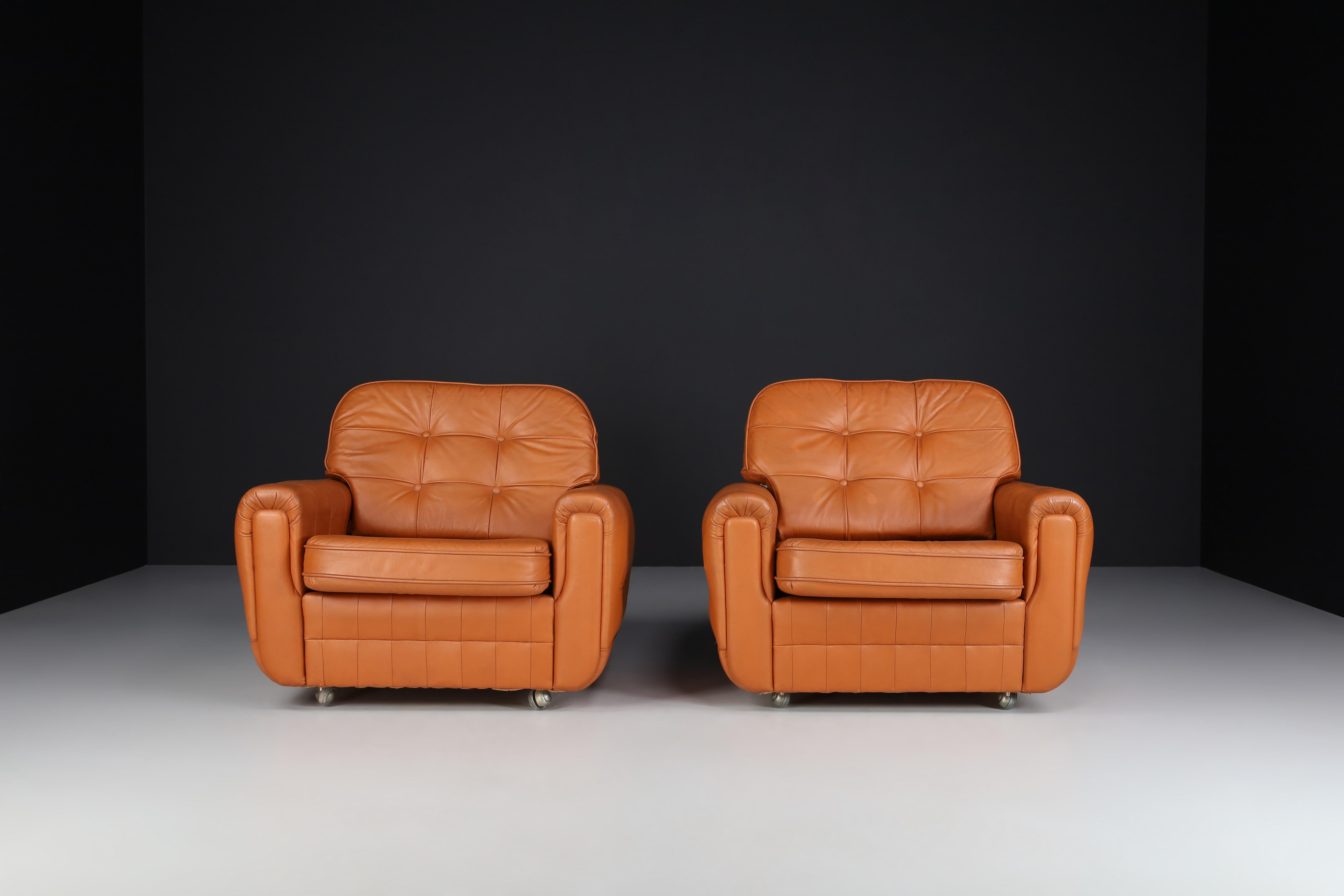 Mid-century leather armchairs manufactured and designed in France 1960s. It is in perfect vintage condition, minor patina on leather parts. These amazing lounge chairs would make an eye-catching addition to any interior such as living room, family