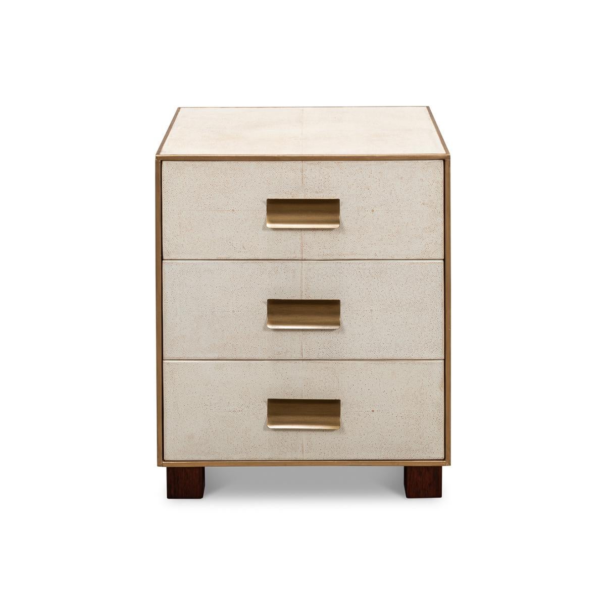 Wrapped in a faux shagreen leather in the osprey white leather. With gold highlights and trim, three drawers raised on short block feet.

Dimensions: 20