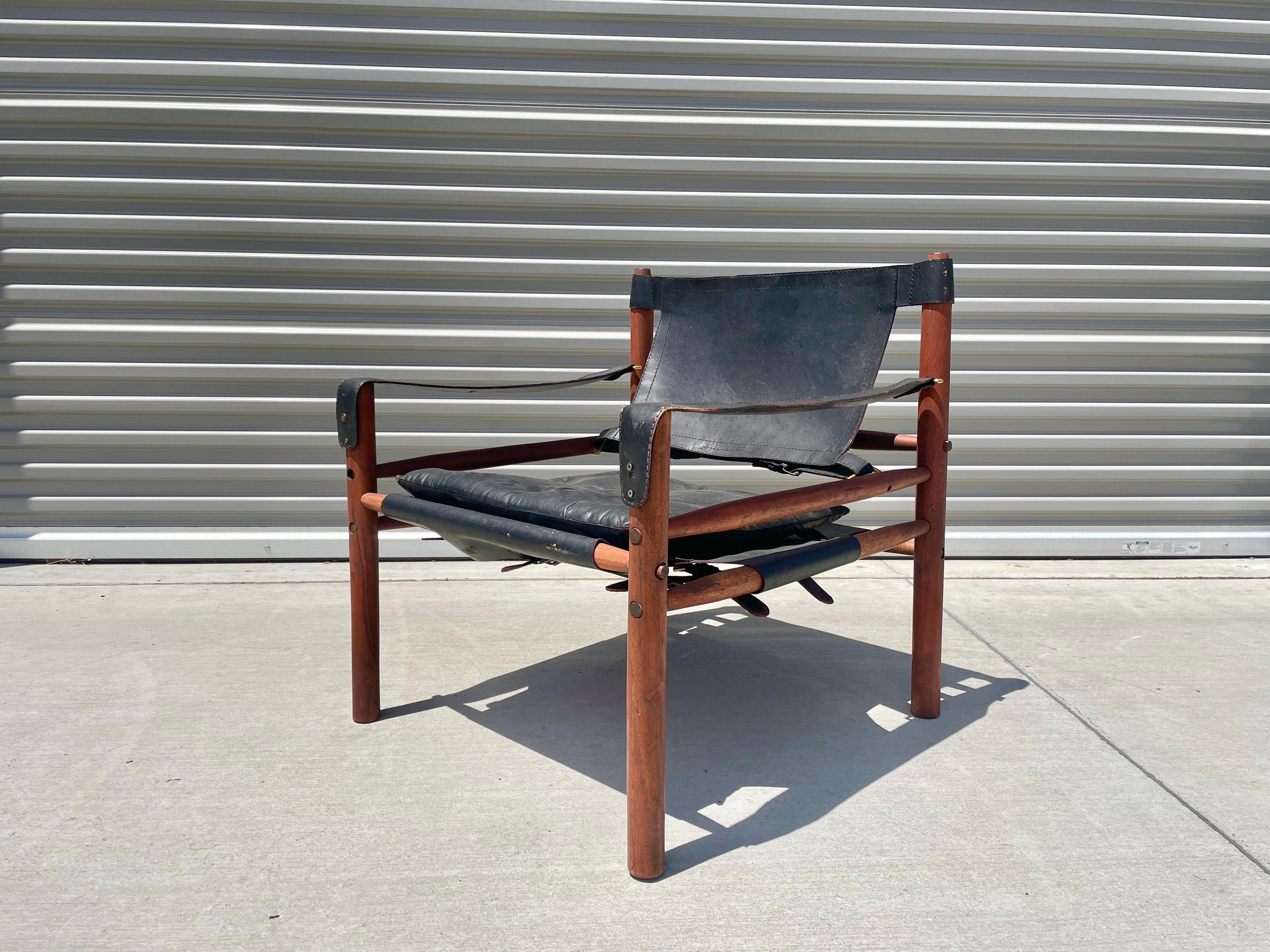 Stunning midcentury leather sirocco safari chair by Arne Norell. This fantastic chair is just one of a kind, from its elegant wood frame to its leather upholstery design. This safari chair is the chair that everyone wants in their home. But this