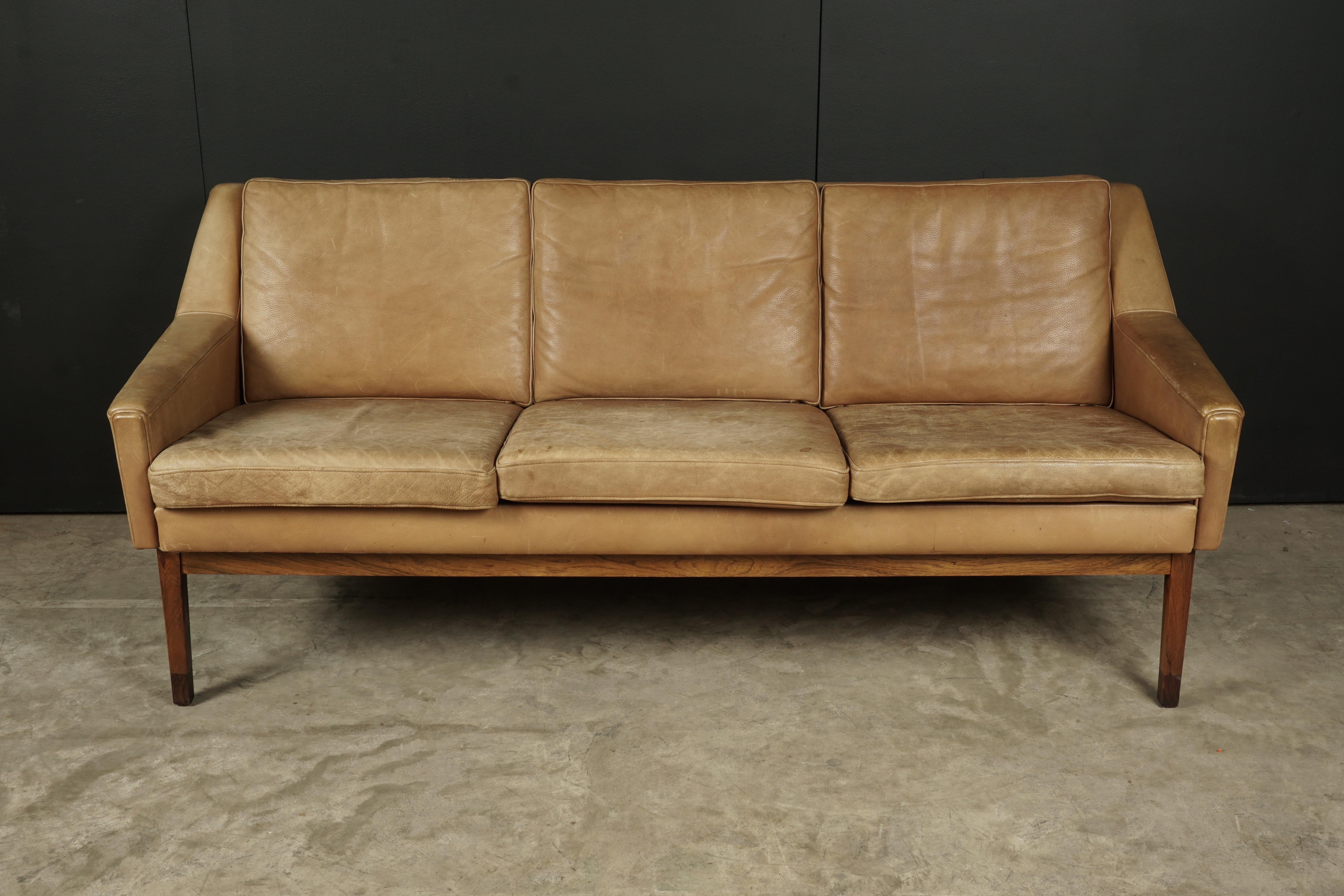 Midcentury leather sofa from Denmark, circa 1970. Original thick tan leather upholstery. Unknown designer. Very good quality and patina.