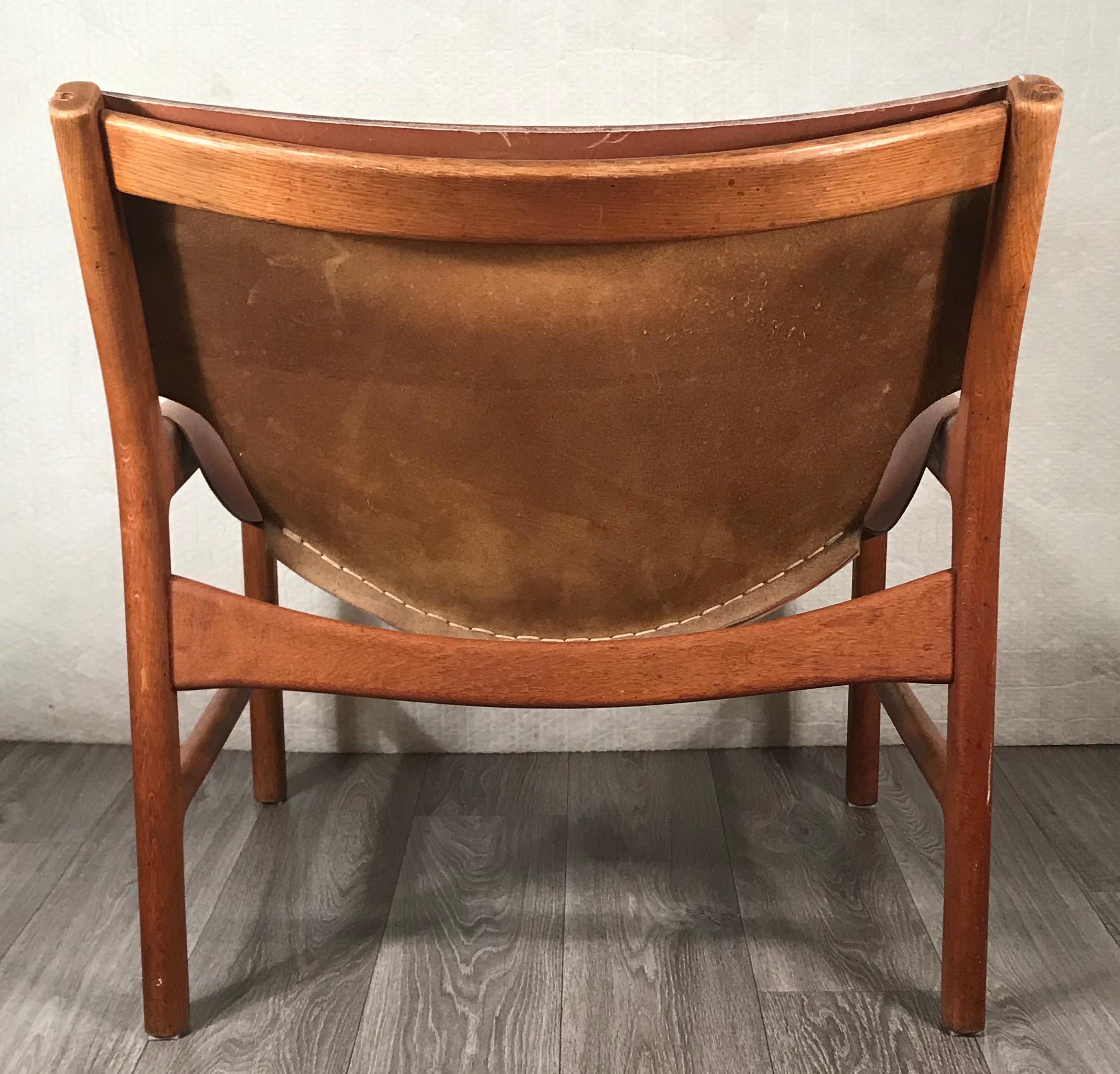 Illum Wikkelsø (1919-1999) for Mikael Laursen, easy chair model no.103, in cognac leather and teak. Made in Denmark in the late 1950s. 
The leather is attached to the wood frame of the chair and offers a very comfortable sitting experience.