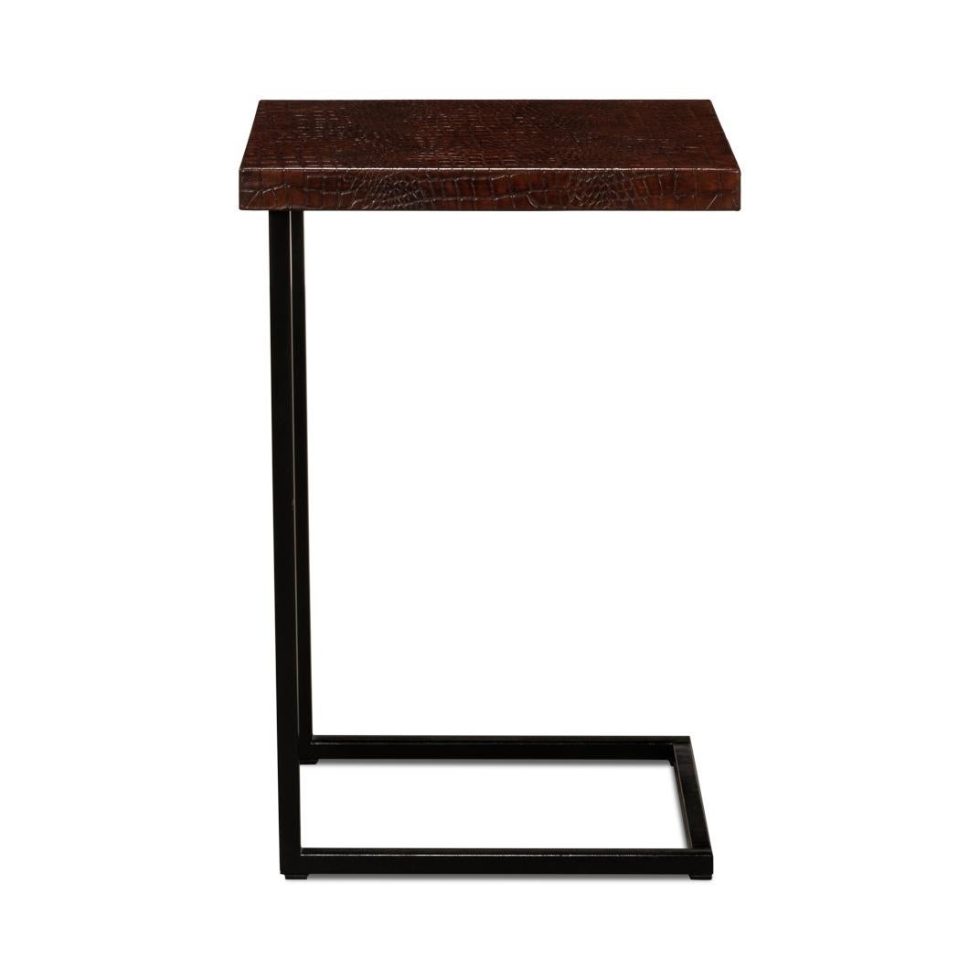 This table celebrates the beauty of understated design with its clean lines and unusual leather top. The sleek, black metal frame creates a striking silhouette that stands out with bold confidence.

The tabletop, a rich croc-embossed leather, boasts