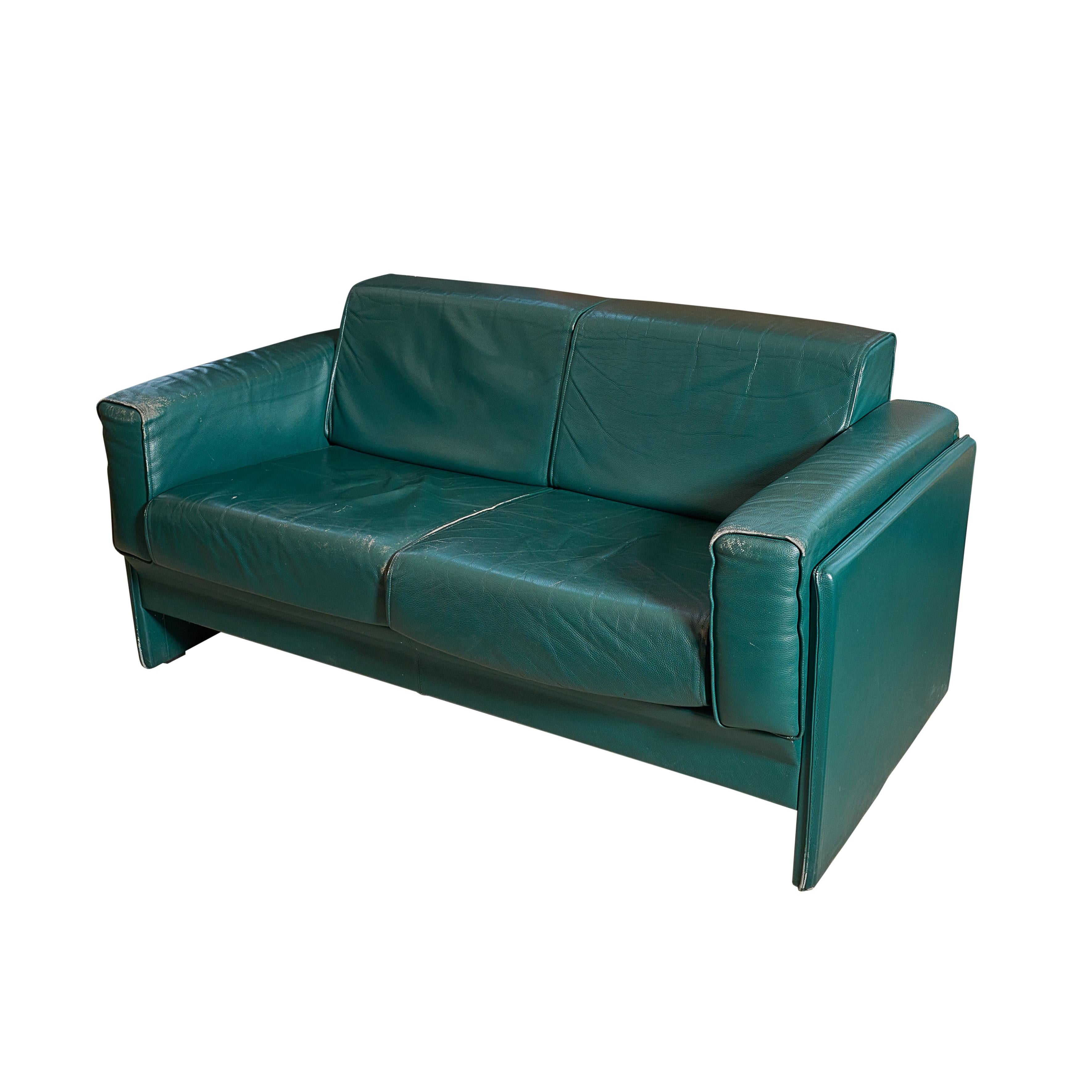 Midcentury sofa / loveseat in green leather from a Milan airport.