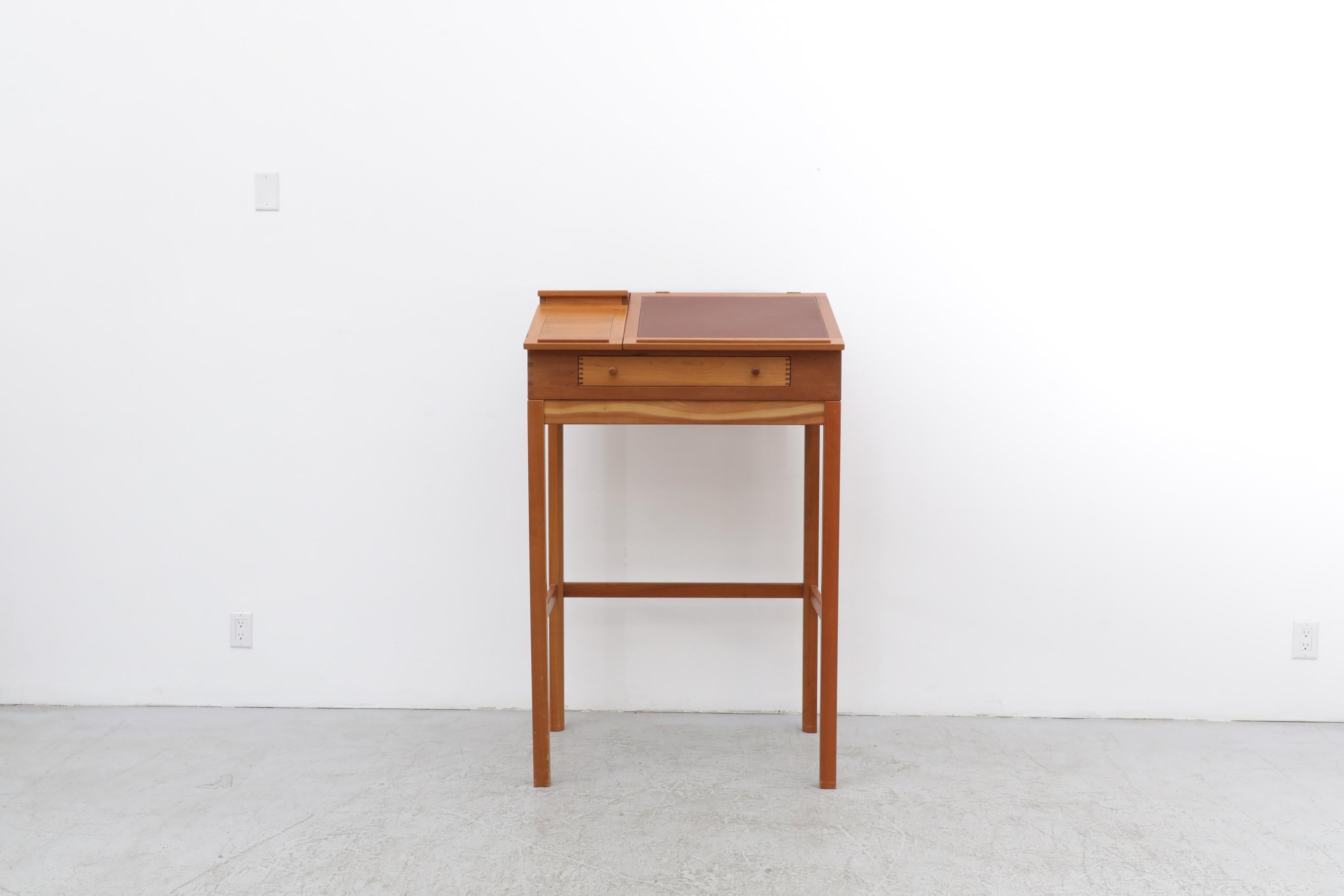 Mid-Century Lectern by Andreas Hansen, Denmark, 1960's. Outfitted with a padded vinyl writing surface, a small drawer, and Andreas Hansen's signature exposed finger joints. The top opens and has some small storage compartments. In original condition