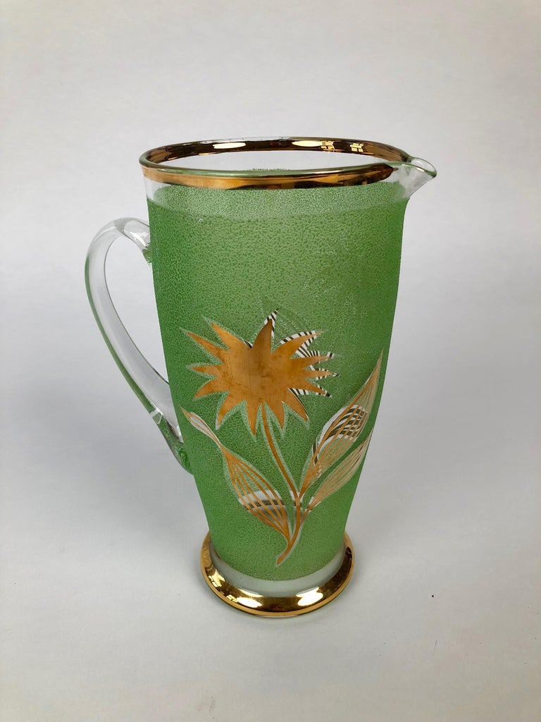 Set of 4 glasses and a pitcher in jade green glass with gold floral application made in Czechoslovakia.
All pieces are in excellent condition, practically never use.