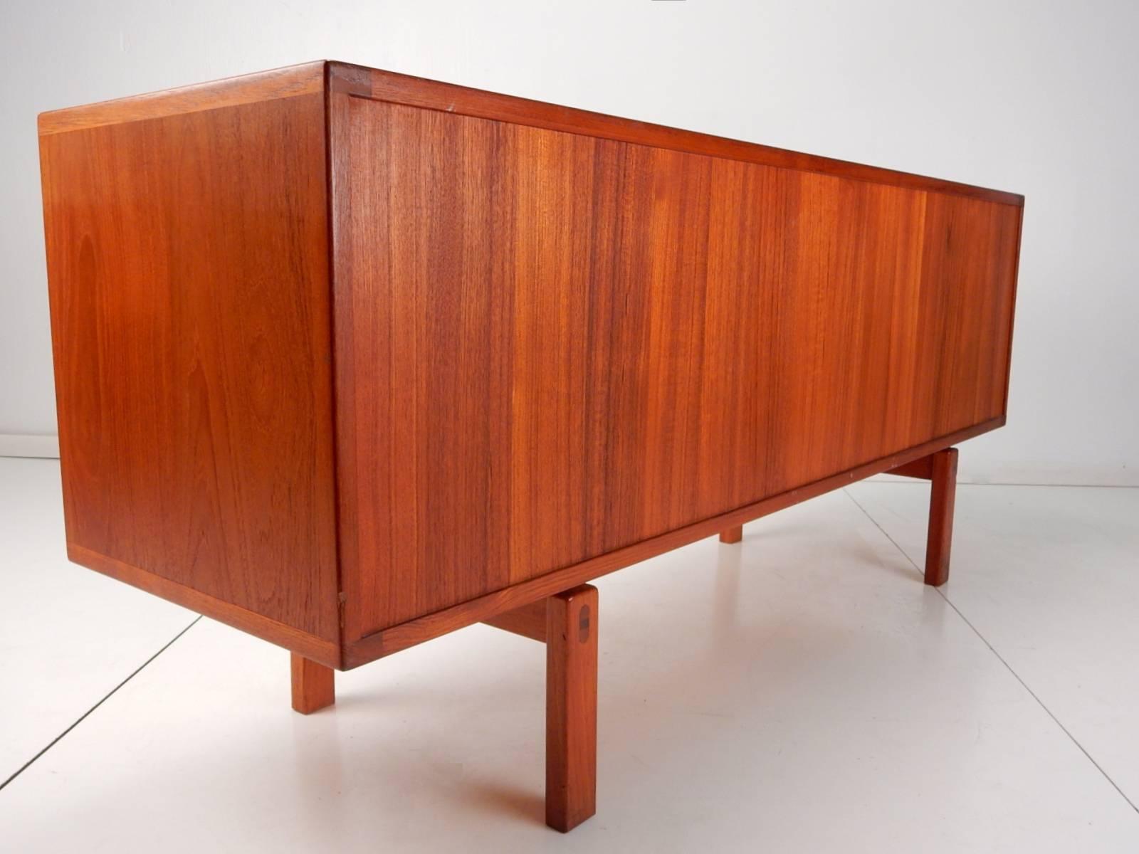 1950s Lennart Bender for Ulferts of Sweden sideboard cabinet from the 'Corona' line.
Teak with rosewood inlay pulls. Beautiful finished back with stupendous grain.
Four drawers with the top being felt lined and a separate mini flatware
