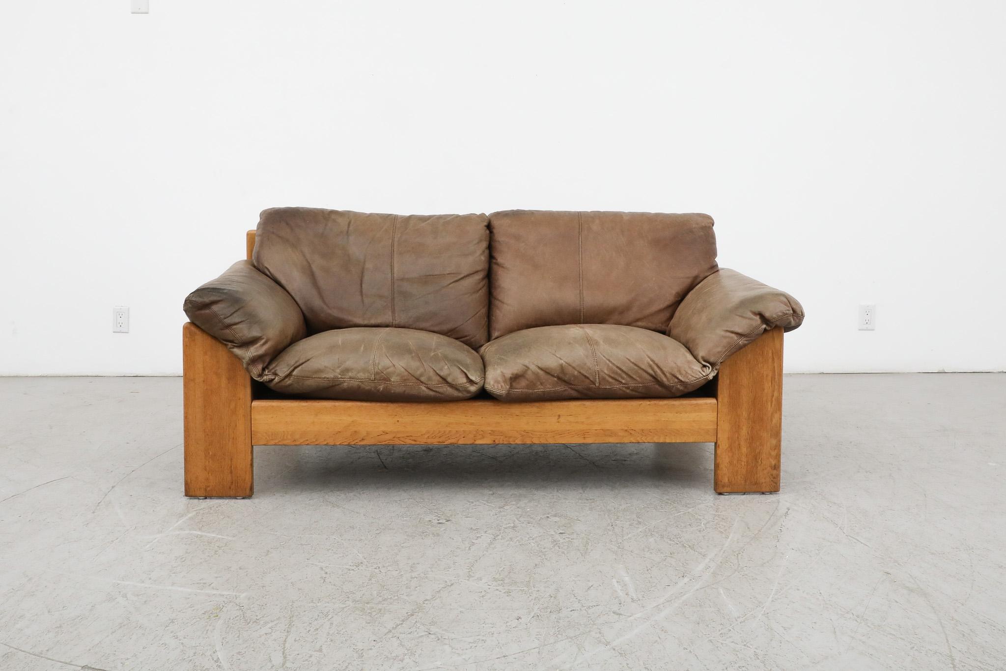 Handsome, Mid-Century Leolux loveseat with beautiful patina. The sofa has a thick natural leather and a lightly refinished oak frame with a matching inset leather back panel. This model is very similar to the Italian 'Sapporo' Sofa by Mobil Girgi.