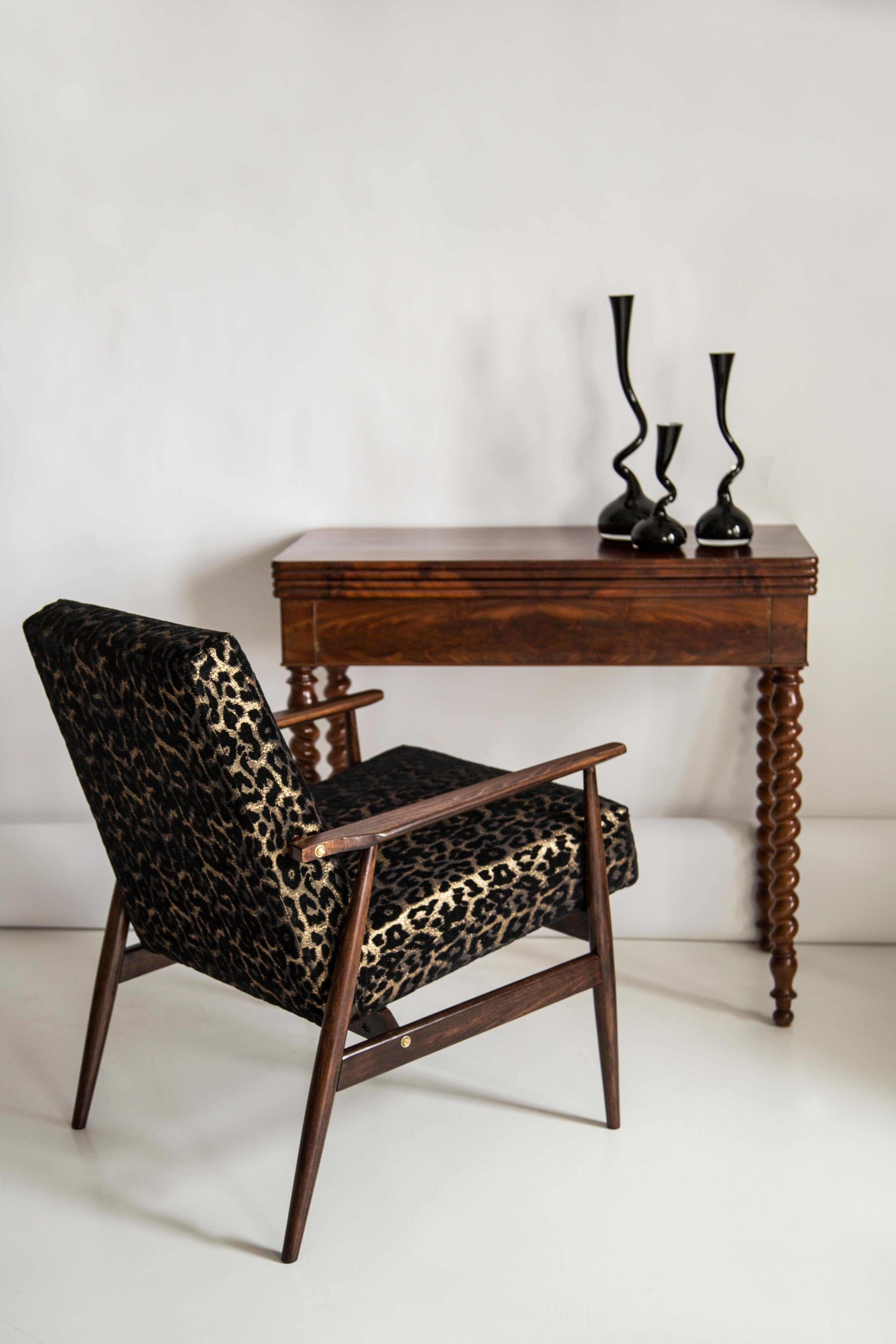 A beautiful, restored armchair designed by Henryk Lis. Furniture after full carpentry and upholstery renovation. The fabric, which is covered with a backrest and a seat, is a high-quality Italian velvet upholstery printed in leopard pattern. The