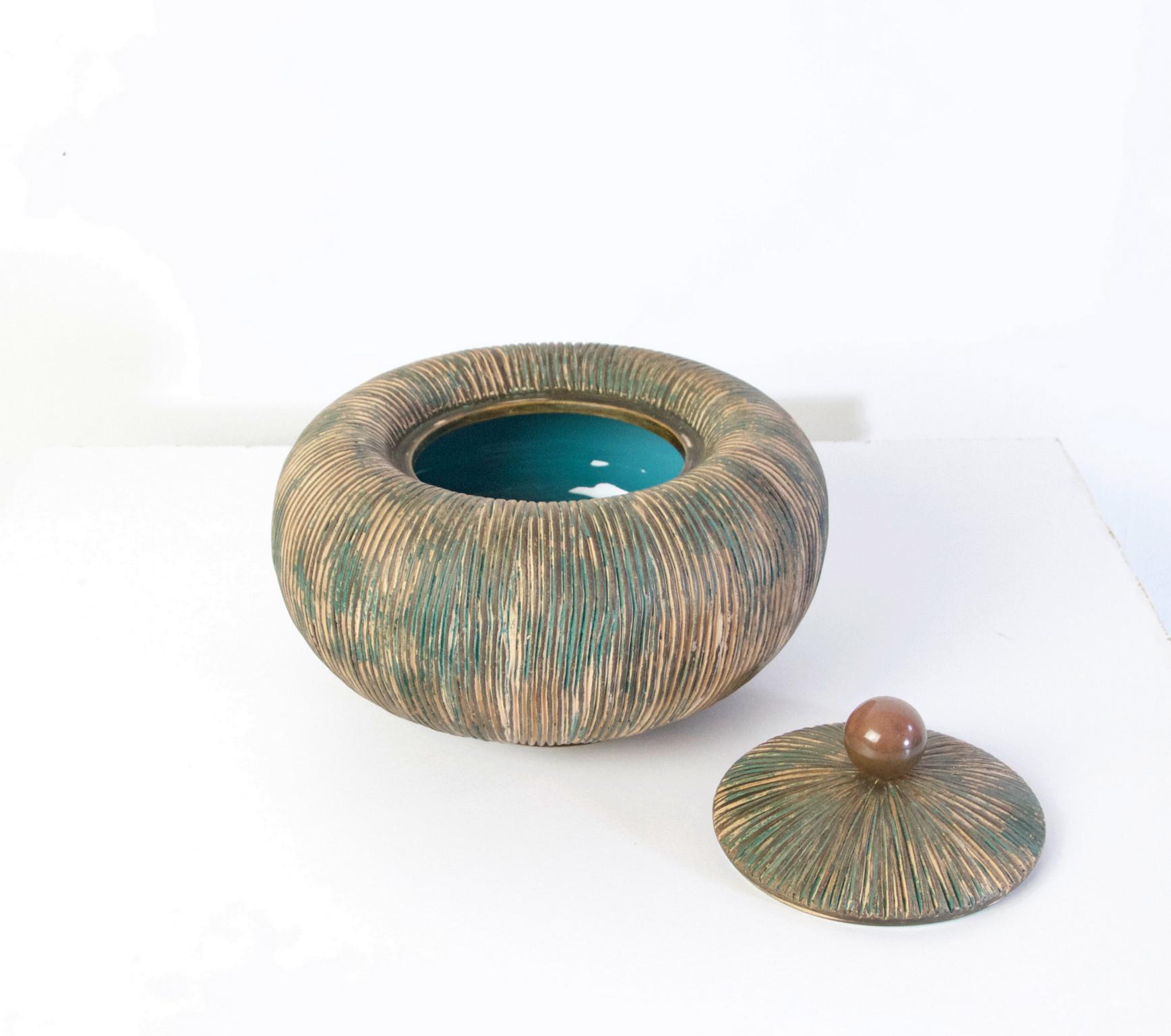 A beautiful pumpkin shaped bowl with lid crowned by a brass handle by Ceramiche Batignani from the 1950's. This handmade bowl is in perfect condition.