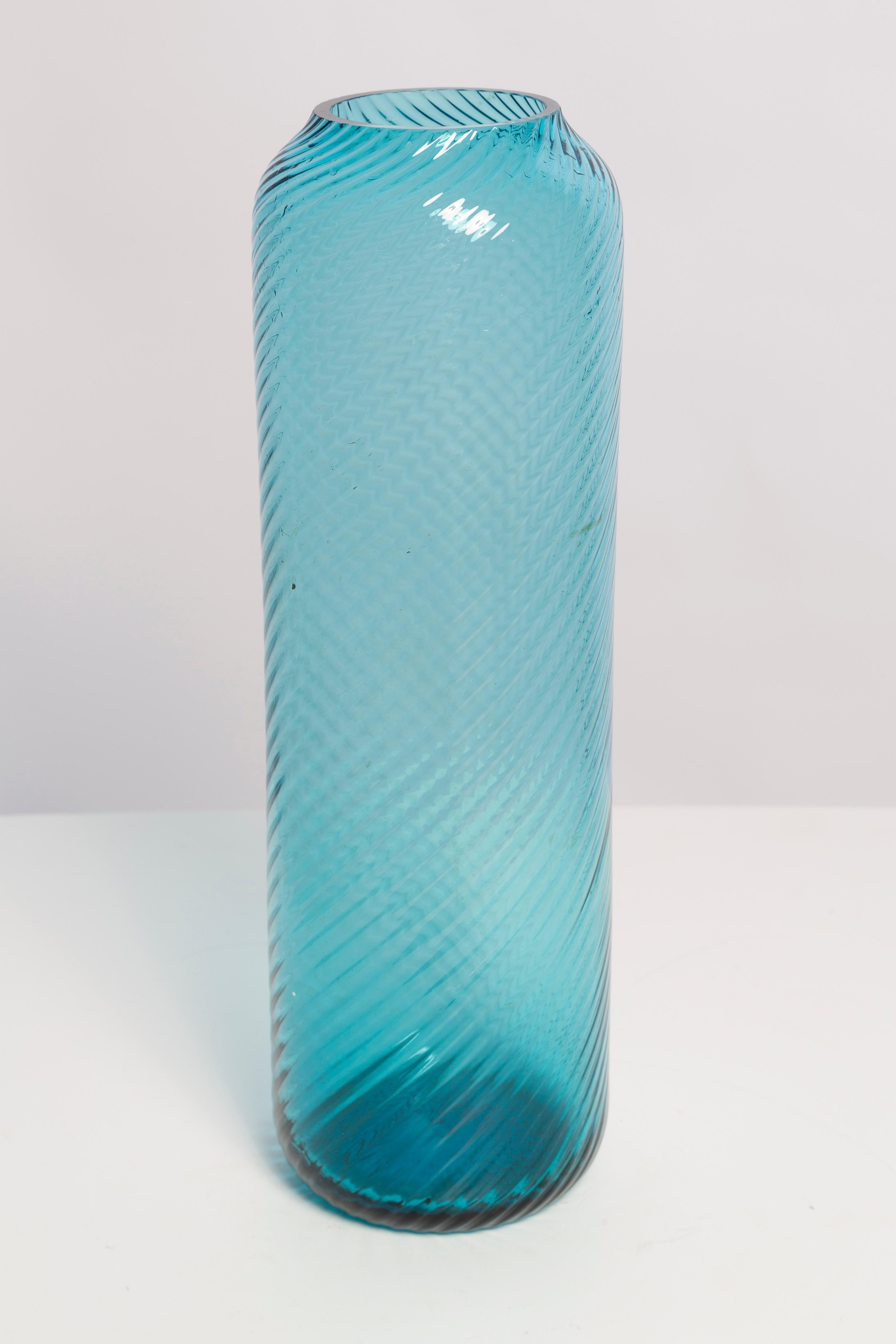 Blue vase in amazing shape. Produced in 1960s.
Glass in perfect condition. The vase looks like it has just been taken out of the box.

No jags, defects etc. The outer relief surface, the inner smooth. 
Thick glass vase, massive.

The irregular
