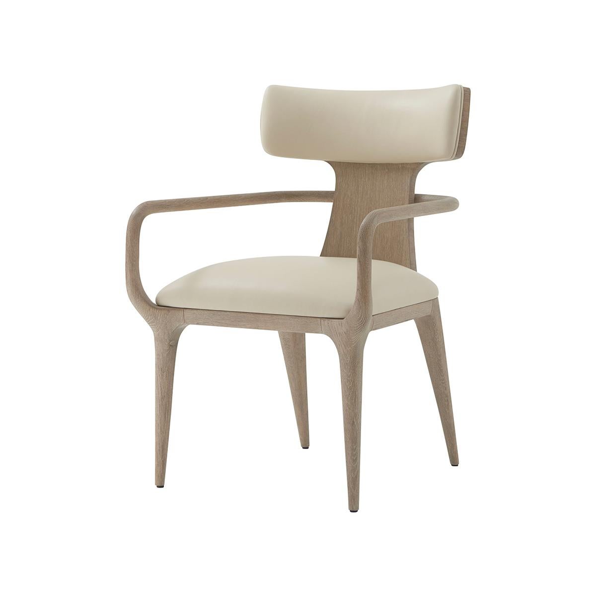 The upholstered dining armchair features a subtle Scandinavian design with a twist on the traditional high-backed design, which makes it unique to your home. Its clean naturally tapered lines of the legs support a plush medium firm density cushioned