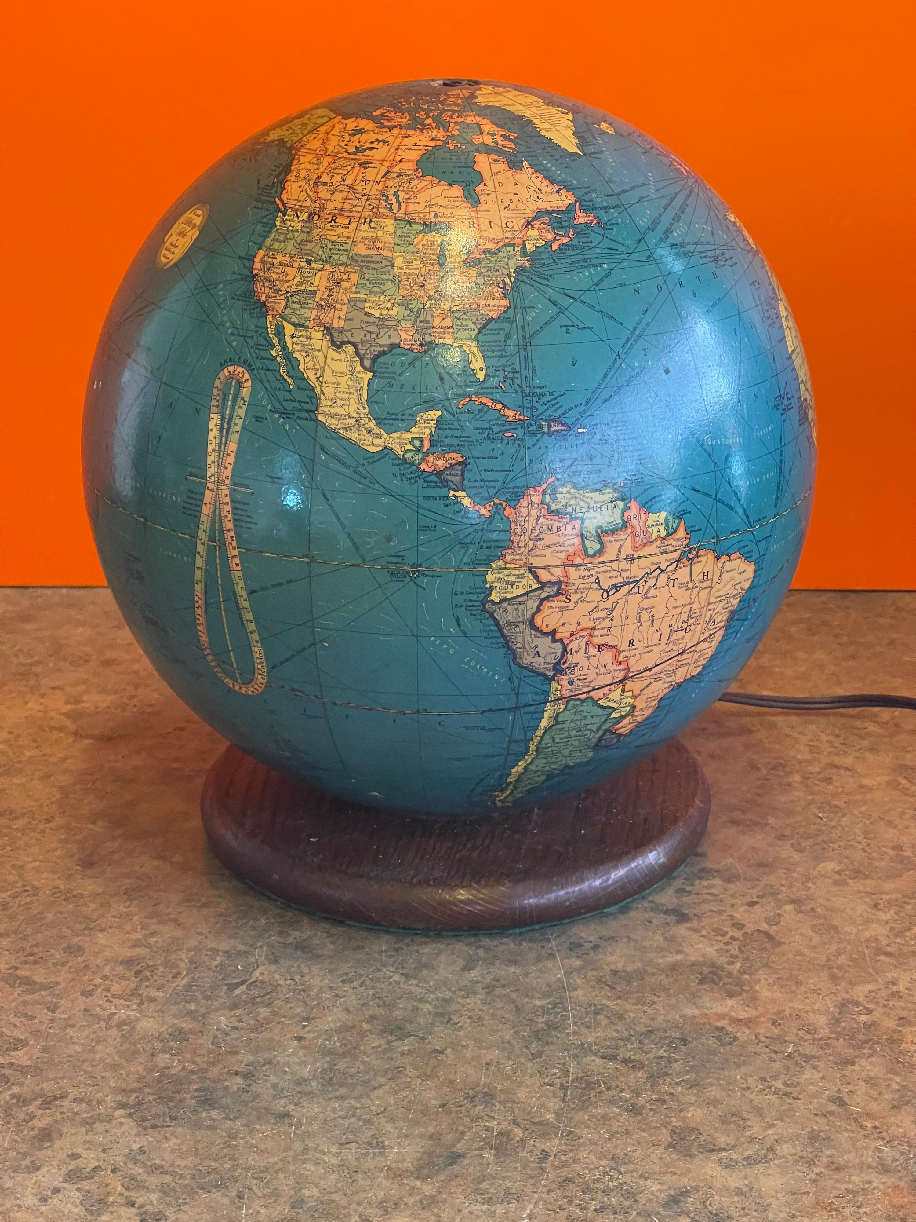 Mid-Century lighted glass globe on oak wood tand by Replogle Globes of Chicago, circa 1950s. This a very cool piece with removable and colorful 10