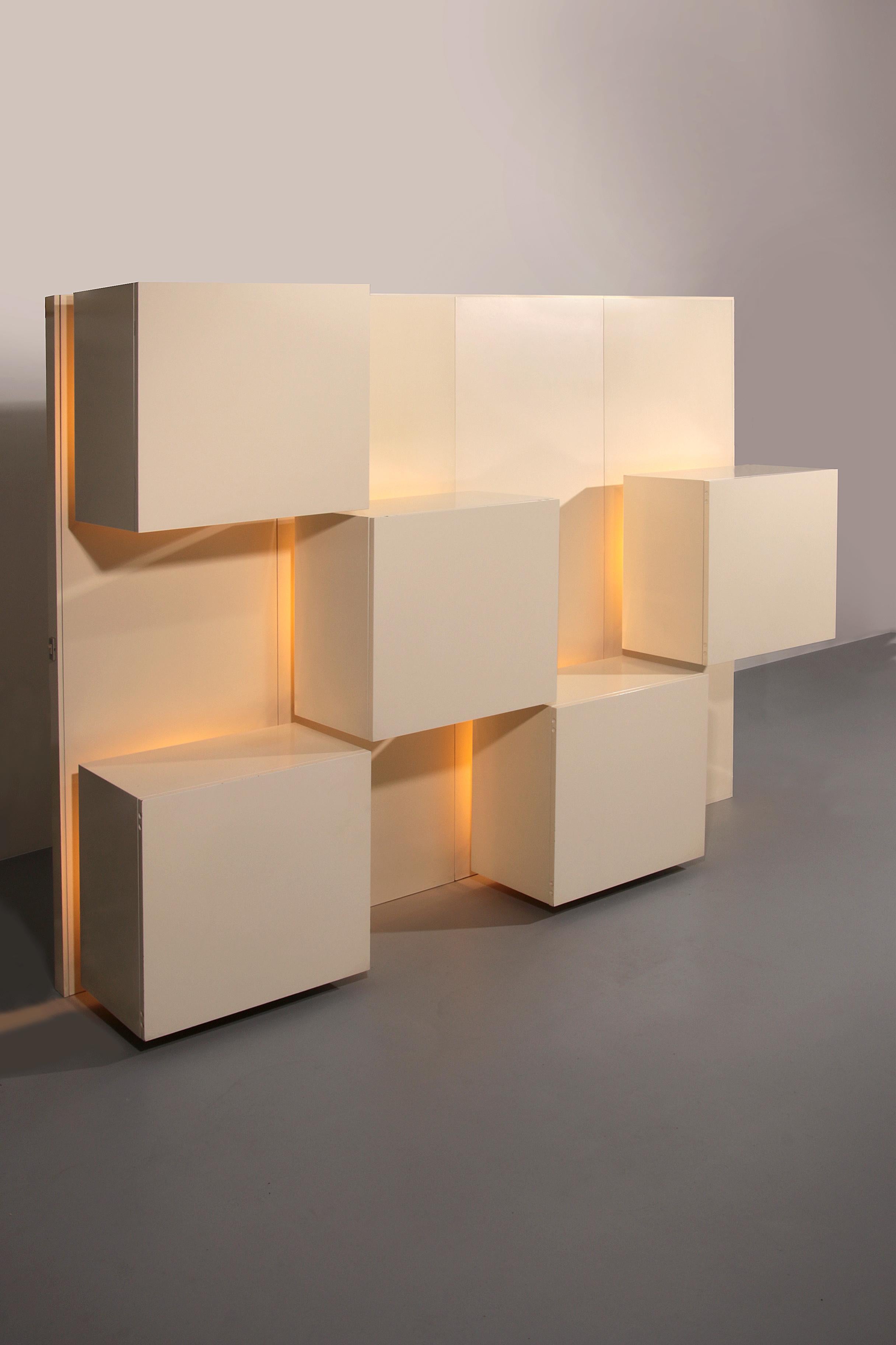 

Roberto Monsani for Acerbis, wall unit, wood and smoked glass, Italy, 1970s Beautiful wall unit by Italian designer Roberto Monsani for Acerbis.

This furniture design shows 5 closed cabinets with shelves, a dry bar and drawers. Behind each