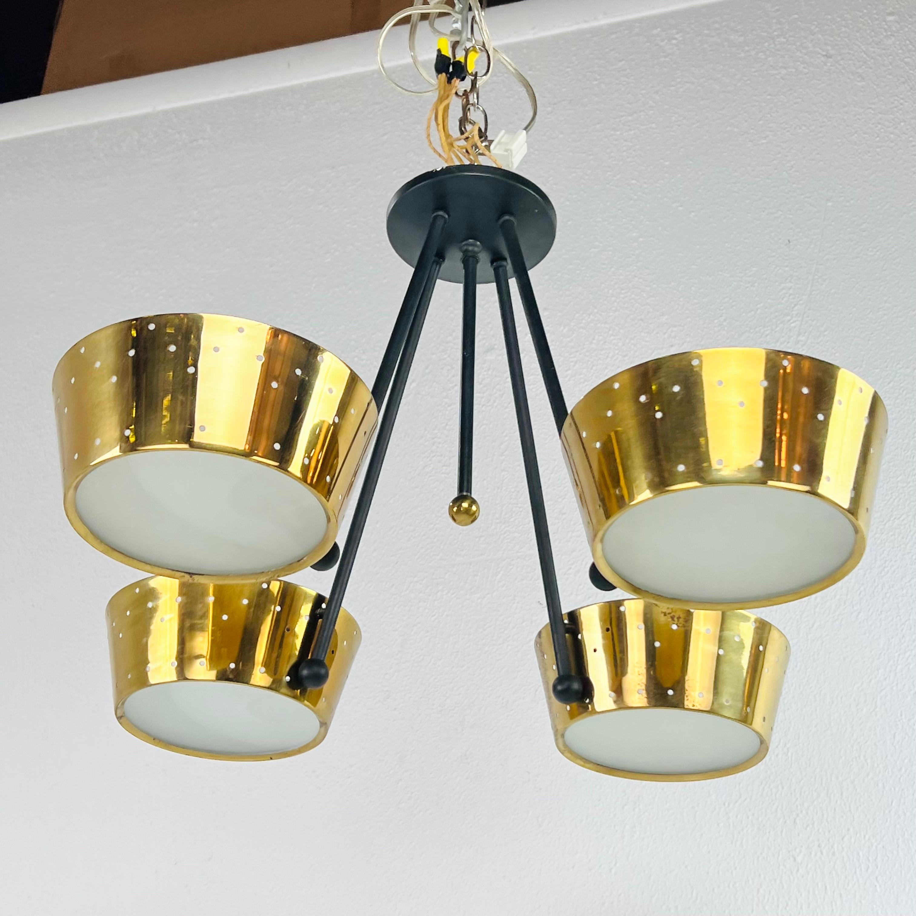 Suspension lamp attributed to Lightolier, in the style of Gerald Thurston, with four polished and perforated brass reflectors, USA 1950. International Brotherhood of Electrical Workers 