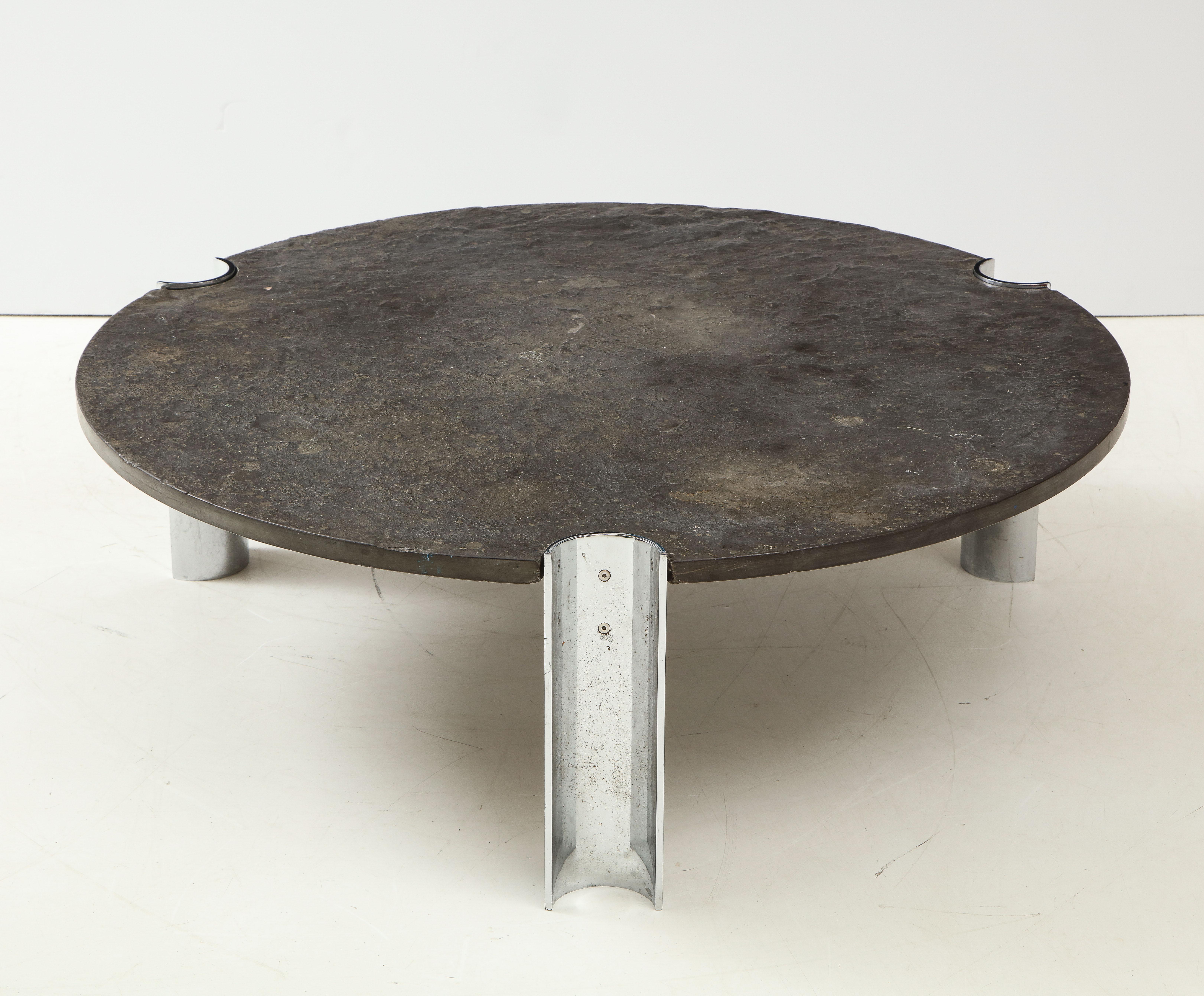 Mid-Century Limestone and Chrome Coffee Table with Fossils, Brazil, c. 1970s. 

This rare and attractive table consists of sleek, industrial chrome legs paired with a round, textured Brazilian limestone top that contains pre-historic fossils in its