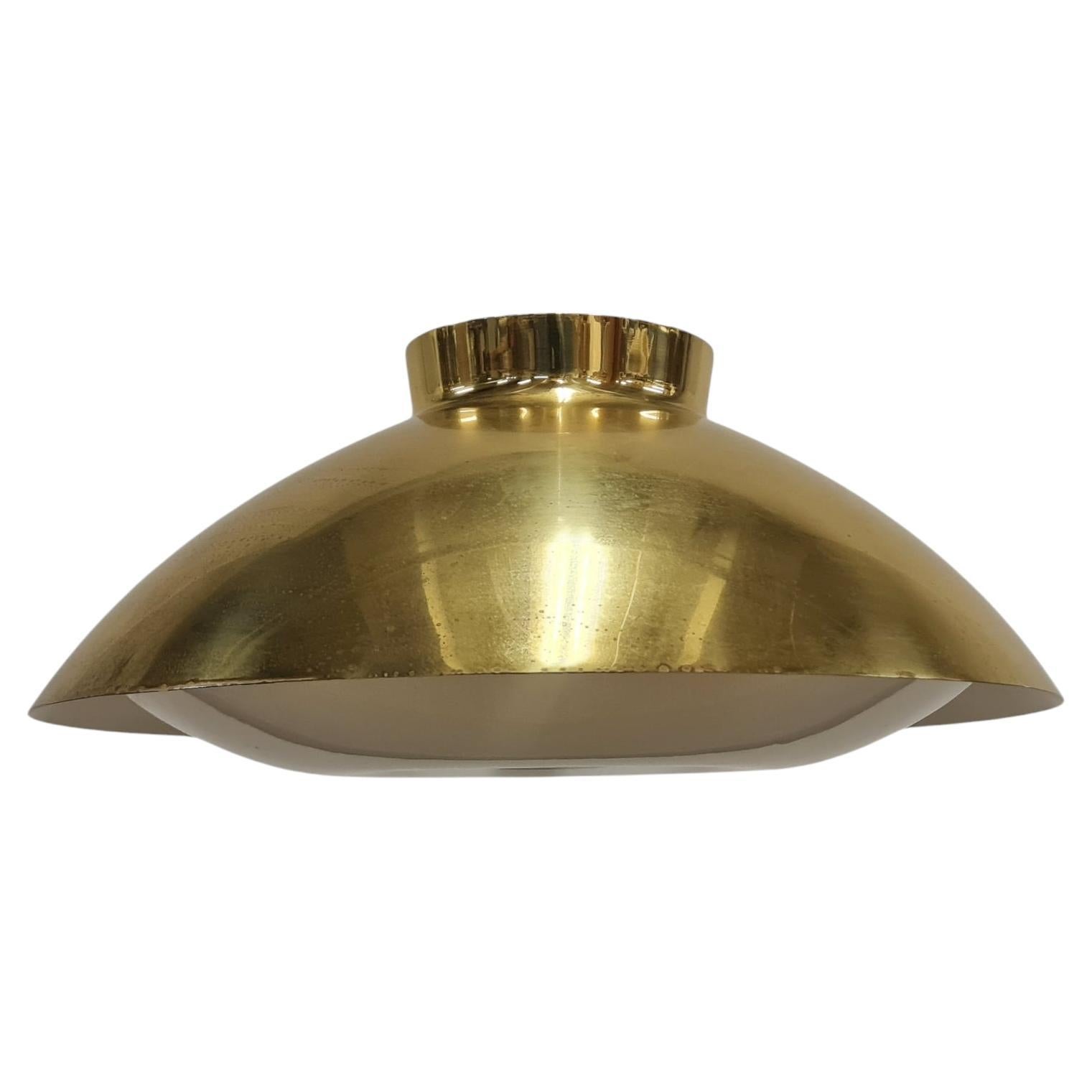 A sizable Mid-Century Modern ceiling lamp model 61-368 designed by Lisa Johansson-Pape, and manufactured by Orno in the 1950s. This lamp is in full brass without perforations as the one in the catalogue. It has an acrylic diffuser at the